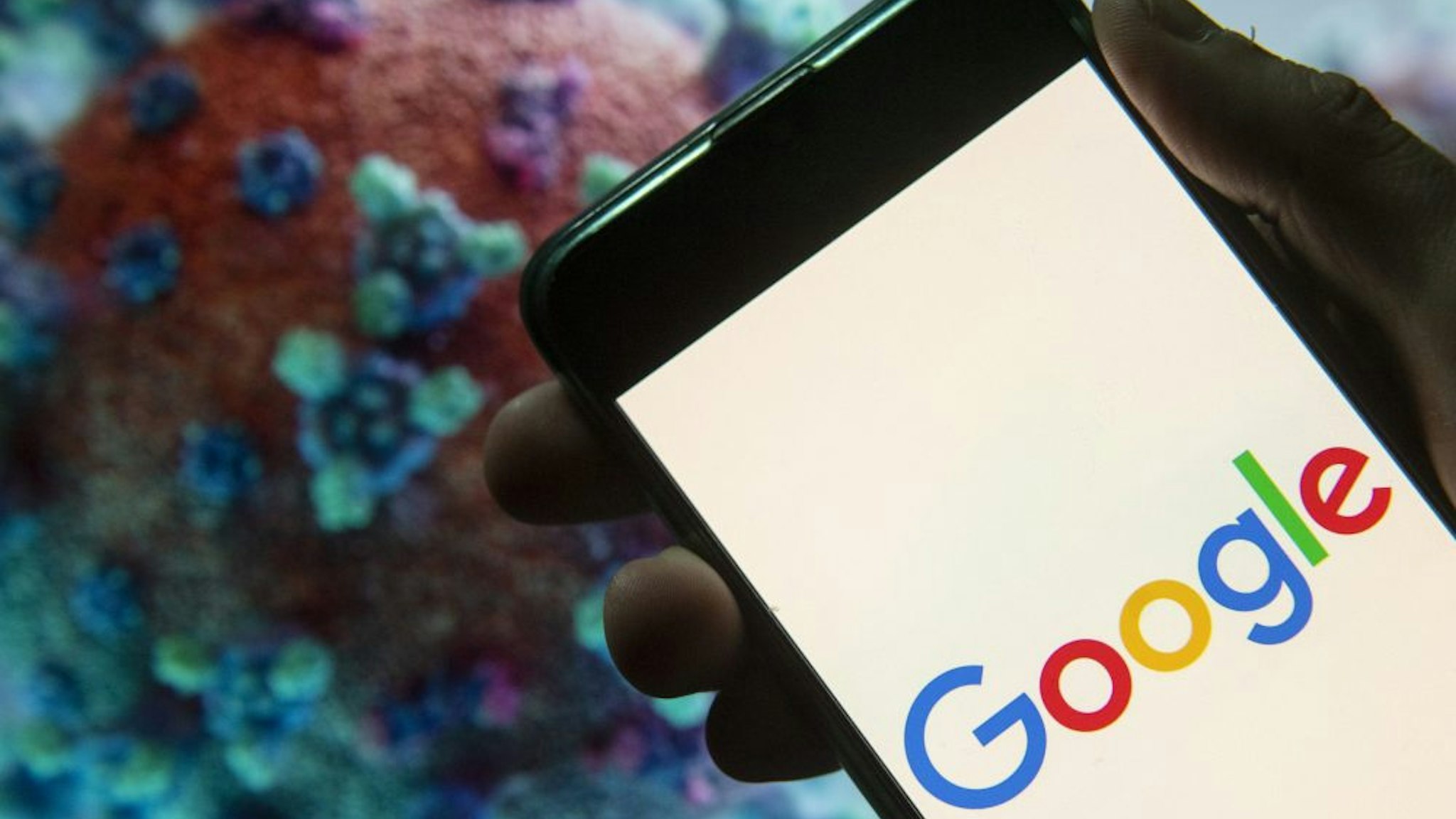 CHINA - 2020/03/23: In this photo illustration the American multinational technology company and search engine Google logo seen displayed on a smartphone with a computer model of the COVID-19 coronavirus on the background.