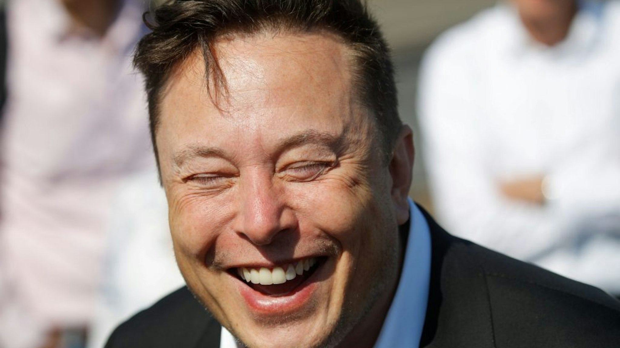 Tesla CEO Elon Musk laughs as he talks to media as he arrives to visit the construction site of the future US electric car giant Tesla, on September 03, 2020 in Gruenheide near Berlin. - Tesla builds a compound at the site in Gruenheide in Brandenburg for its first European "Gigafactory" near Berlin.