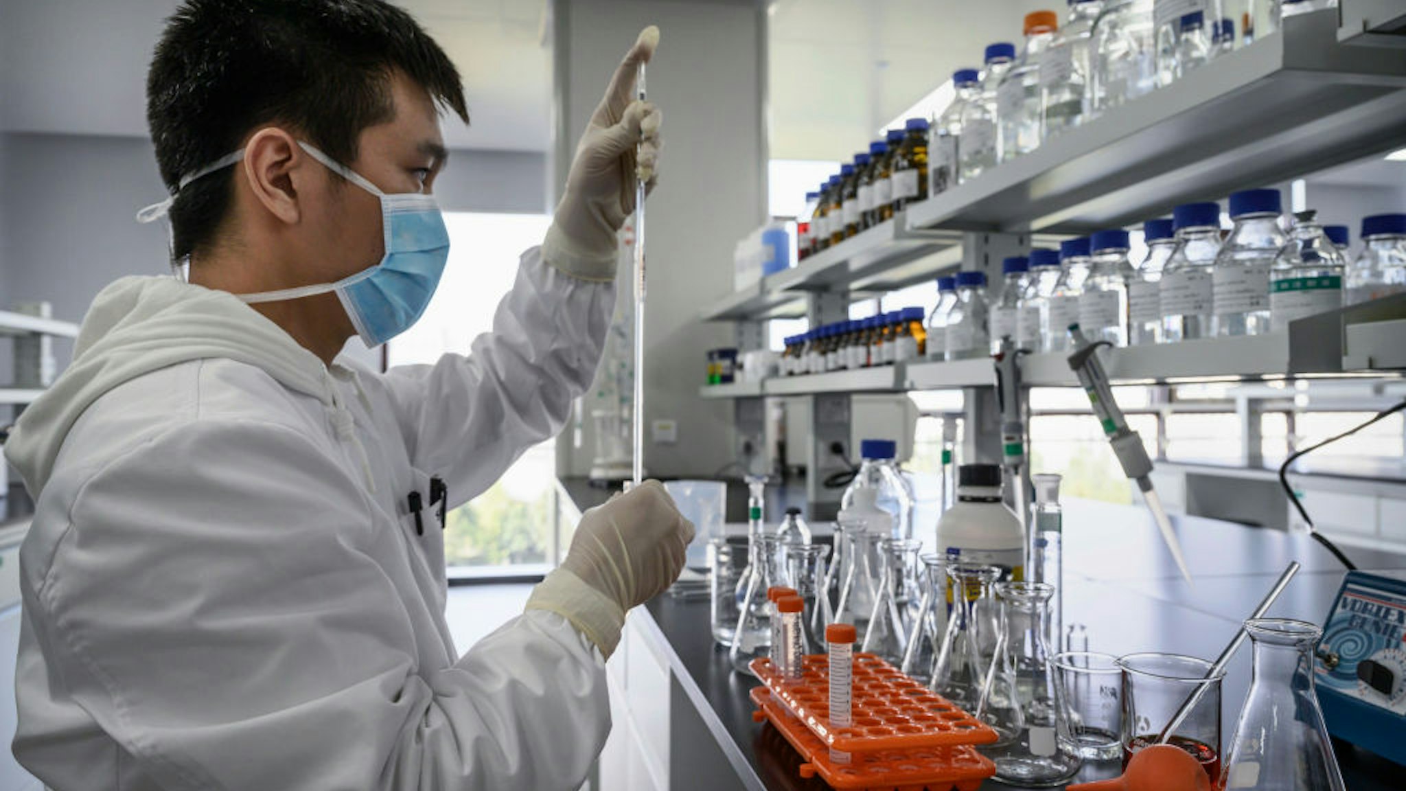 BEIJING, CHINA - SEPTEMBER 24: A technician works in a lab at Sinovac Biotech where the company is producing their potential COVID-19 vaccine CoronaVac during a media tour on September 24, 2020 in Beijing, China. Sinovacs inactivated vaccine candidate, called CoronaVac, is among a number of companies in the global race to control the coronavirus pandemic. The company is running Phase 3 human trials in four countries and ramping up production to 300 million doses per year at a new manufacturing facility south of Beijing. A lack of domestic coronavirus cases in China has meant that companies developing vaccines have shifted their focus overseas to conduct trials to gather the volume of data necessary to win regulatory approvals. When Chinas government launched an emergency use program in July to vaccinate groups of essential workers, Sinovacs chief executive says the company supplied tens of thousands of doses, even as trials are still underway. About 90% of Sinovacs employees have chosen to receive injections of CoronaVac, which is one of eight Chinese vaccine candidates in human trials. The company is also seeking approval to begin clinical trials with teenagers and children as young as age 3.(Photo by Kevin Frayer/Getty Images)