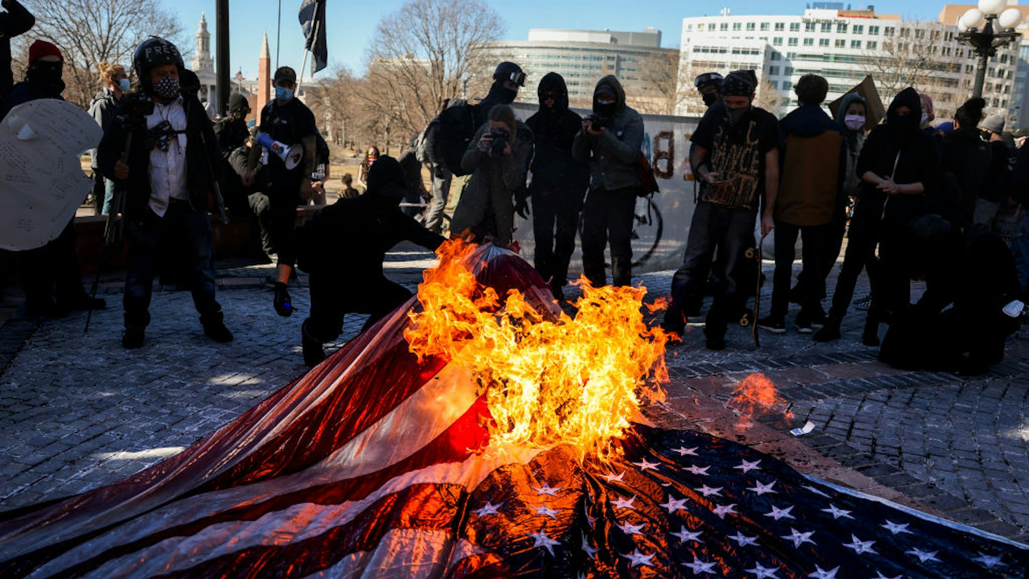 DENVER, CO - JANUARY 20: Members of the Communist Party USA and other anti-fascist groups burn an American flag on the steps of the Colorado State Capitol on January 20, 2021 in Denver, Colorado. Joe Biden was sworn in as the 46th President of the United States with Vice President Kamala Harris at an inauguration ceremony in Washington DC earlier in the day. (Photo by Michael Ciaglo/Getty Images)