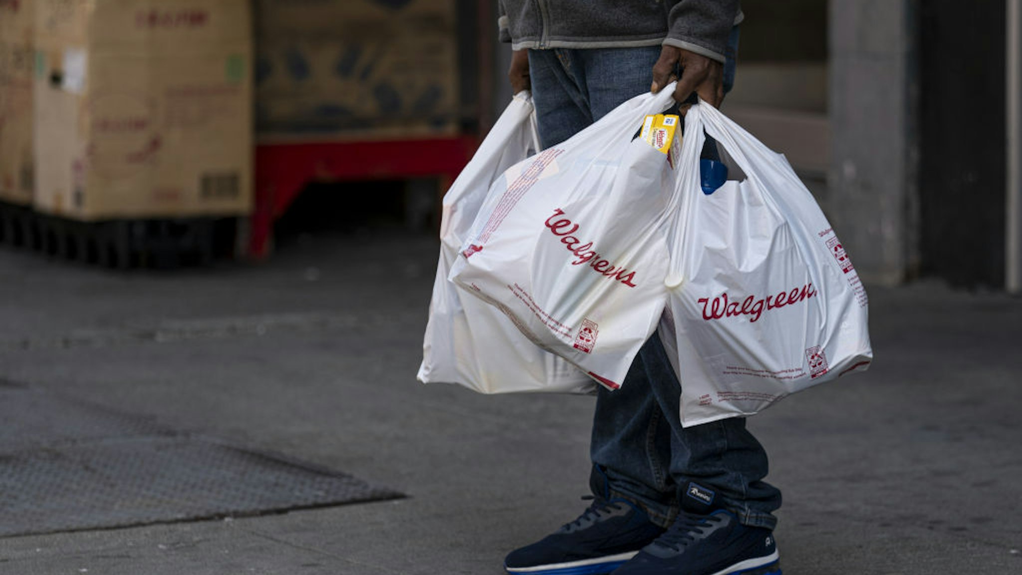 A person holds Walgreens shopping bags in front of a store in San Francisco, California, U.S., on Tuesday, April 13, 2021. Walgreens Boots Alliance Inc. is scheduled to release earnings figures on April 15. Photographer: David Paul Morris/Bloomberg via Getty ImagesA person holds Walgreens shopping bags in front of a store in San Francisco, California, U.S., on Tuesday, April 13, 2021. Walgreens Boots Alliance Inc. is scheduled to release earnings figures on April 15. Photographer: David Paul Morris/Bloomberg via Getty Images