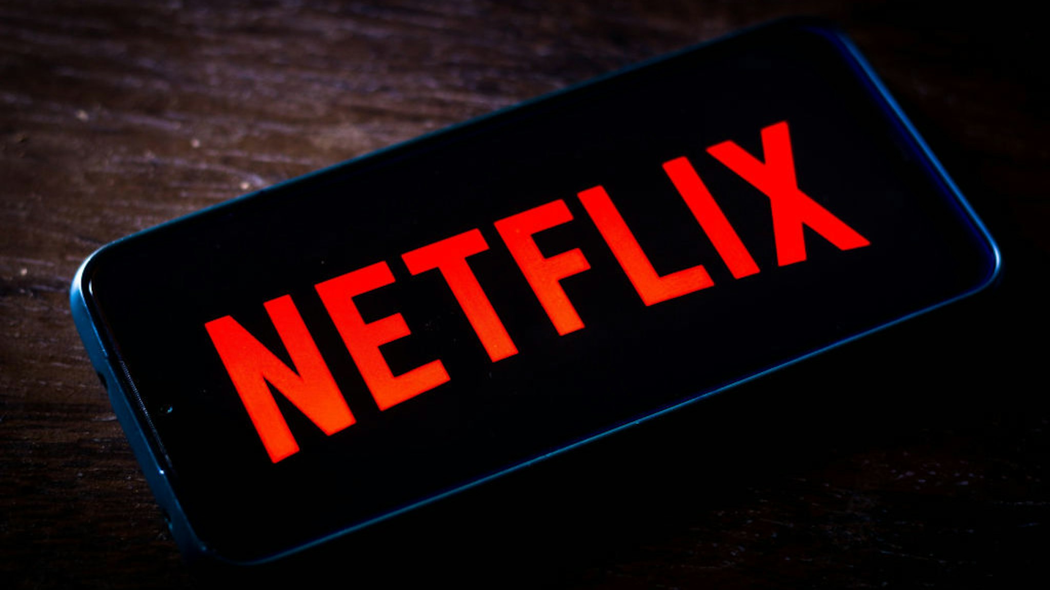 In this photo illustration the Netflix logo seen displayed on a smartphone screen.