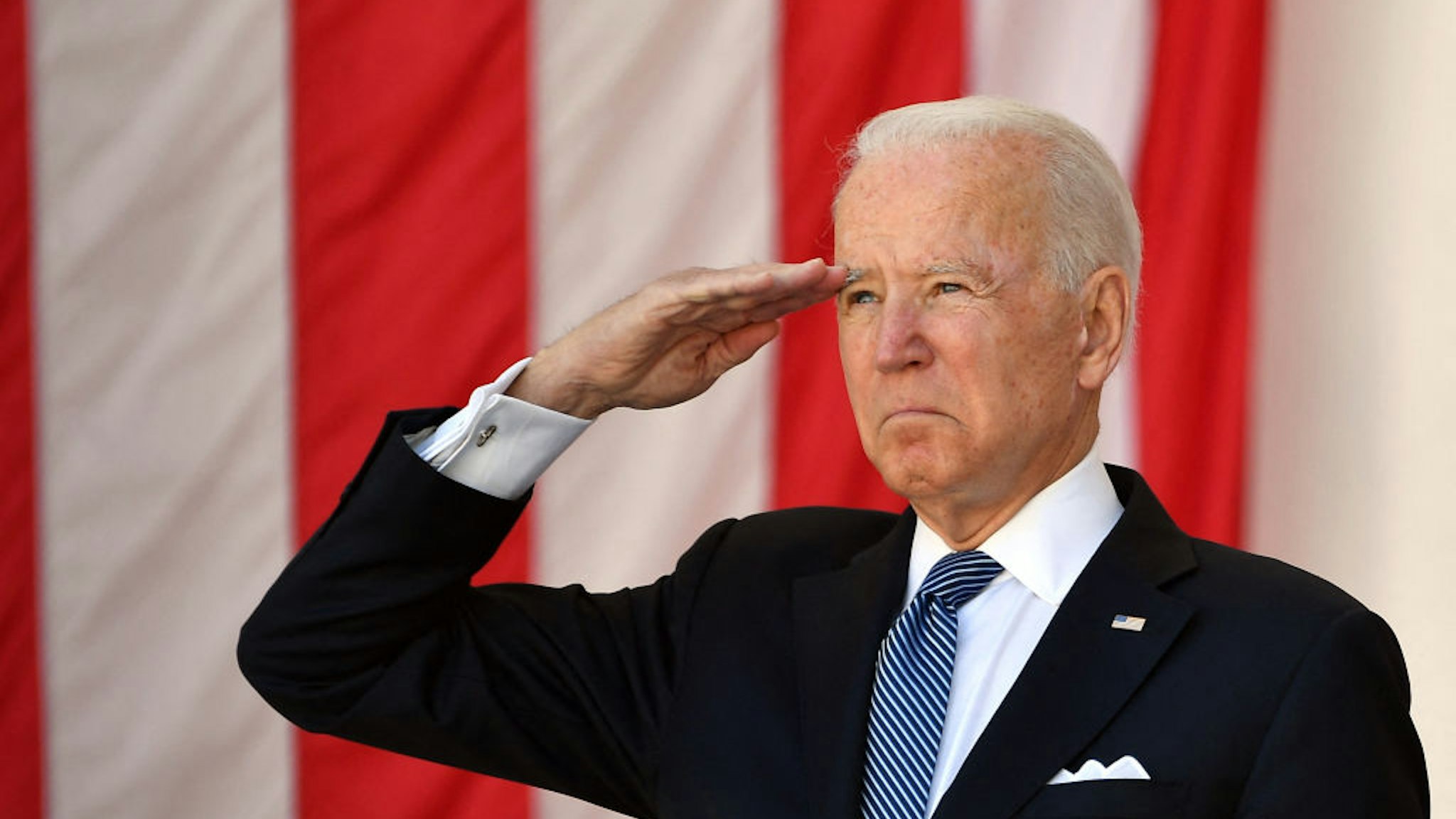 US President Joe Biden salutes before delivering an address at the 153rd National Memorial Day Observance at Arlington National Cemetery on Memorial Day in Arlington, Virginia on May 31, 2021.