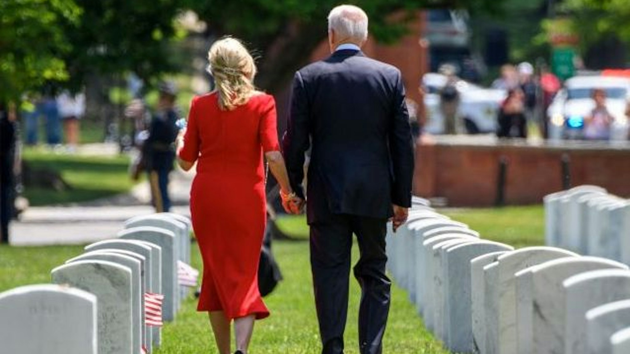 US President Joe Biden and First Lady Jill Biden walk through Section 12 of Arlington National Cemetery, after the 153rd National Memorial Day Observance on Memorial Day in Arlington, Virginia on May 31, 2021. (Photo by MANDEL NGAN / AFP) (Photo by MANDEL NGAN/AFP via Getty Images)