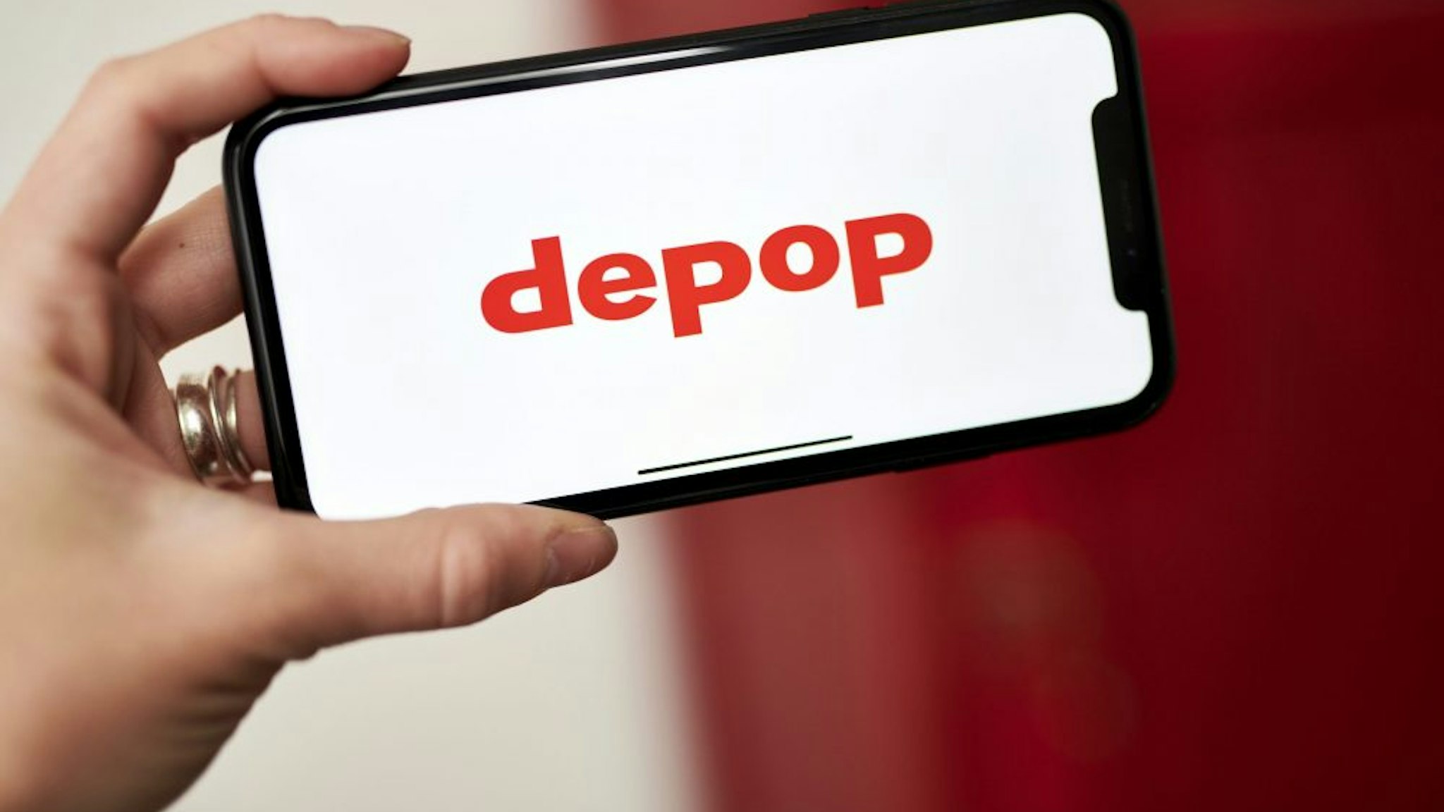 The Depop logo on a smartphone arranged in the Brooklyn borough of New York, U.S., on Wednesday, June 2, 2021. Etsy Inc., the online marketplace for crafts and vintage items, is buying second-hand fashion app Depop for $1.63 billion as it seeks to expand its customer base and attract younger users.