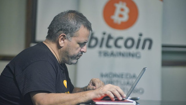 CHILTUIPAN, LA LIBERTAD, EL SALVADOR - 2021/06/07: A man works on a laptop at a Bitcoin training facility. Salvadoran President Nayib Bukele has announced that he will propose a law to the Congress, where his party controls a majority, for Bitcoin to become legal tender. El Salvador would become the first country in the world to accept a cryptocurrency as a legal tender.