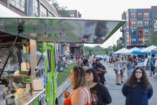 Patrons receive refreshments at food trucks during Franklinton Fridays.