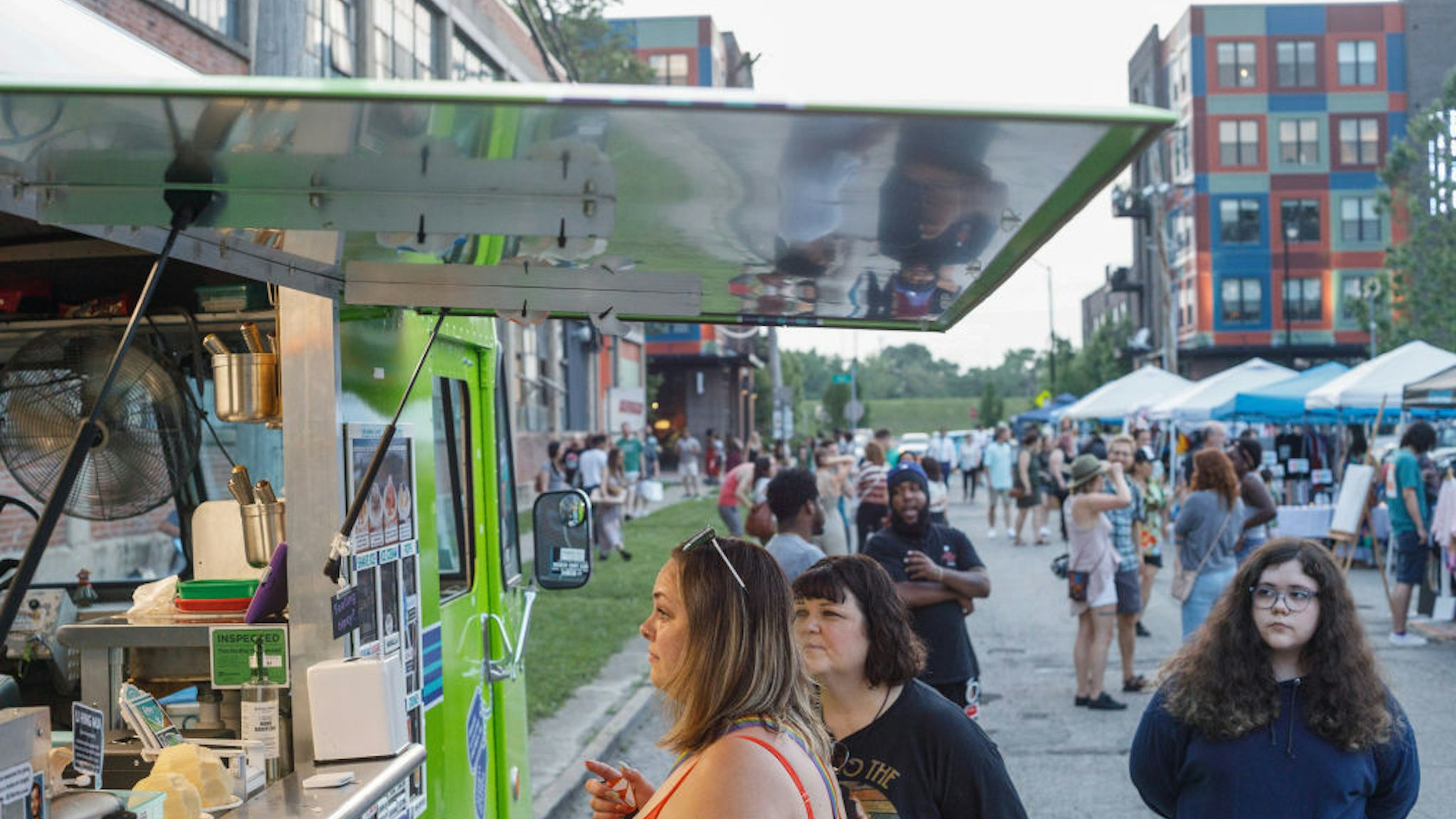 Patrons receive refreshments at food trucks during Franklinton Fridays.