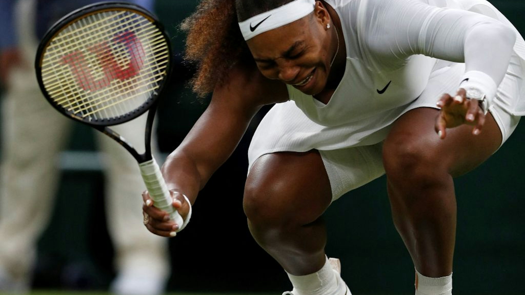 US player Serena Williams reacts as she pulls-up injured before withdrawing from her women's singles first round match against Belarus's Aliaksandra Sasnovich on the second day of the 2021 Wimbledon Championships at The All England Tennis Club in Wimbledon, southwest London, on June 29, 2021. - RESTRICTED TO EDITORIAL USE (Photo by Adrian DENNIS / AFP) / RESTRICTED TO EDITORIAL USE (Photo by ADRIAN DENNIS/AFP via Getty Images)