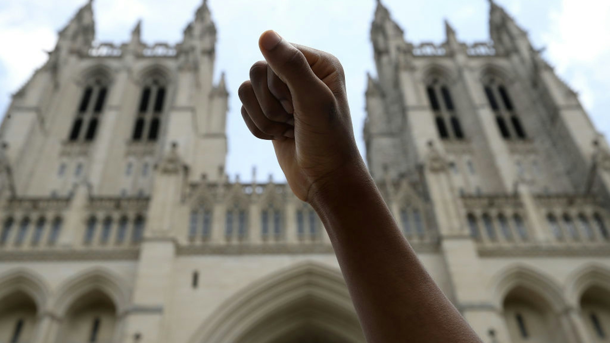 WASHINGTON, DC - JUNE 05: A student holds up a fist during a Black Lives Matter sit-in at the National Cathedral during a peaceful protest against police brutality and the death of George Floyd, on June 5, 2020 in Washington, DC. Protests in cities throughout the country are largely peaceful in the wake of the death of George Floyd, a black man who was killed in police custody in Minneapolis on May 25. (Photo by Win McNamee/Getty Images)