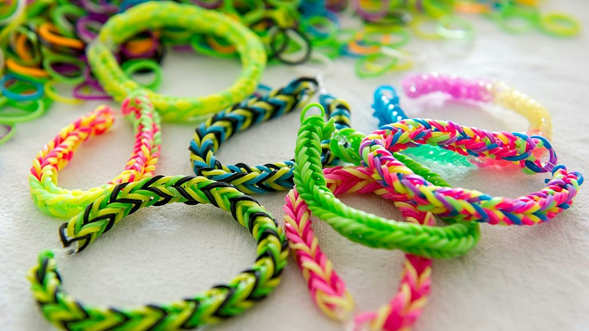 A photo taken on July 23, 2014 in Lille, northern France, shows "Rainbow Loom" bracelets. "Rainbow Loom" bracelets, made with coloured small elastic bands woven, are the new fashion imported from the United States. AFP PHOTO / PHILIPPE HUGUEN (Photo credit should read PHILIPPE HUGUEN/AFP via Getty Images)