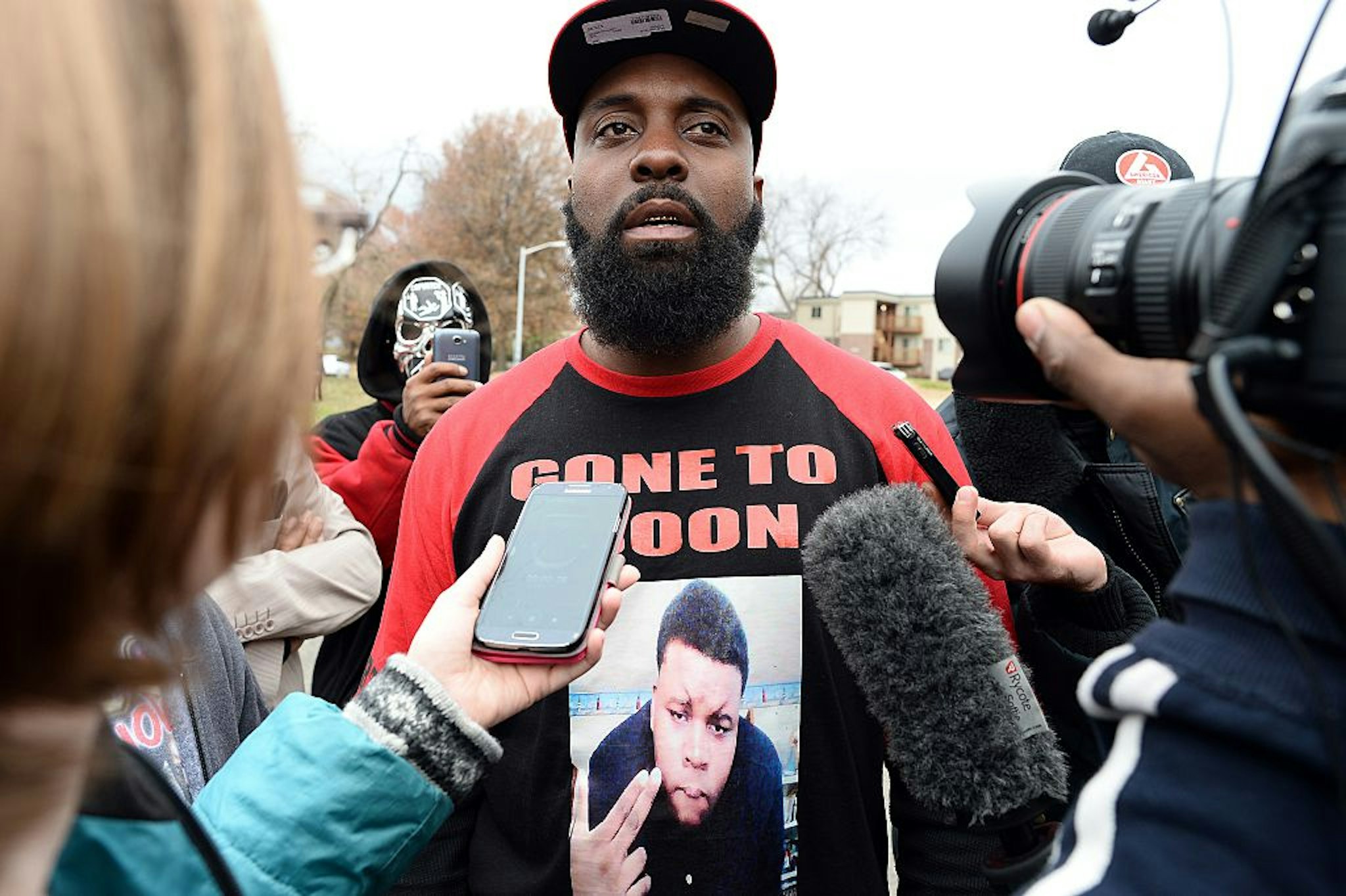 Michael Brown Sr. (C), the father of 18-year-old Michael Brown who was shot dead by a police officer, speaks to journalists as he distributes turkeys for Thanksgiving where his son was killed in Ferguson, Missouri, on November 22, 2014.