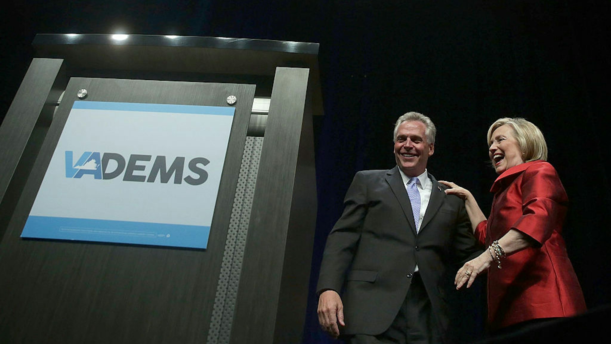 Democratic U.S. presidential hopeful and former U.S. Secretary of the State Hillary Clinton and Virginia Governor Terry McAuliffe share a moment during the Democratic Party of Virginia Jefferson-Jackson dinner June 26, 2015 at George Mason University's Patriot Center in Fairfax, Virginia.