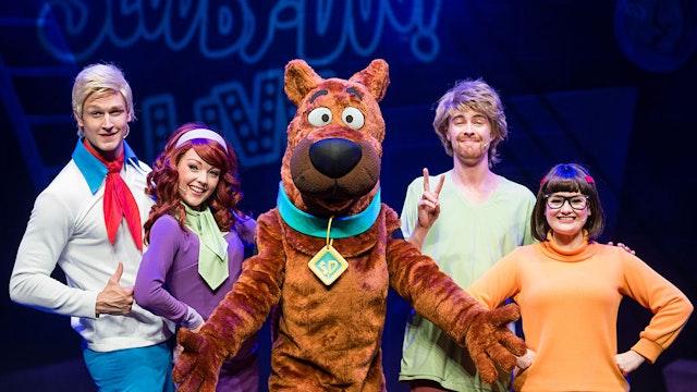 LONDON, ENGLAND - AUGUST 17: (L-R) Chris Warner Drake as Fred, Charlie Bull as Daphne, Joe Goldie as Scooby-Doo, Charlie Haskins as Shaggy and Rebecca Withers as Velma appear on stage in Scooby-Doo Live! at London Palladium on August 17, 2016 in London, England.