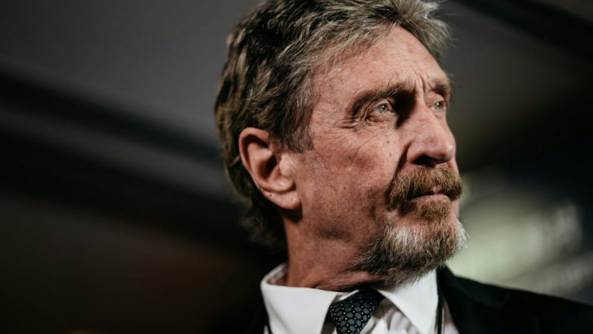 John McAfee, founder of McAfee Associates Inc. and chief cybersecurity visionary at MGT Capital Investments Inc., listens during a Bloomberg Television interview on the sidelines of the Shape the Future: Blockchain Global Summit in Hong Kong, China, on Wednesday, Sept. 20, 2017. McAfee, who now runs a bitcoin mining company, says China's banning of initial coin offerings won't halt the momentum of cryptocurrencies globally.
