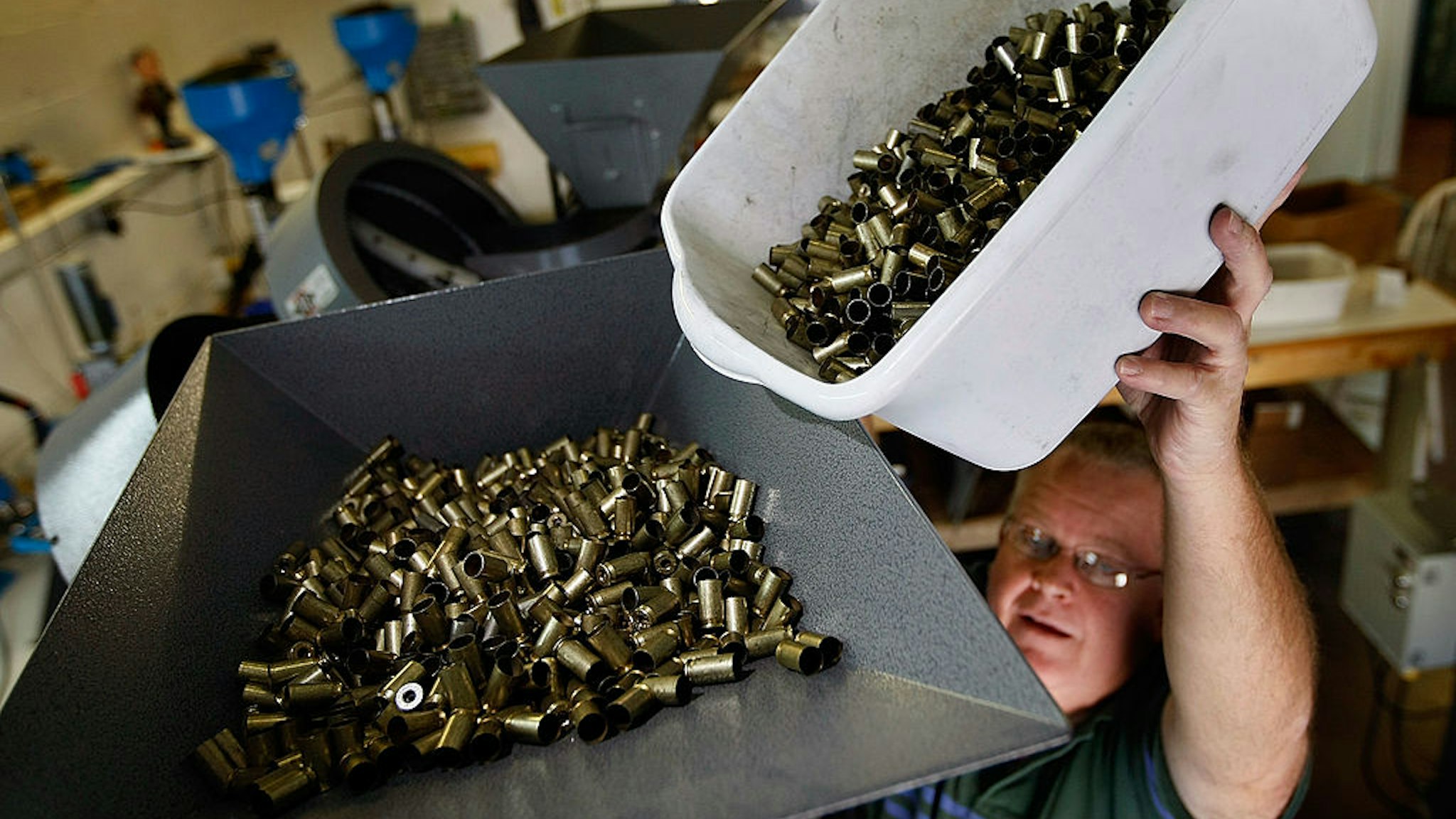 MIAMI - APRIL 09: Adolfo Vivas pours bullet casing into an ammuntion loader as they manufacture 45 caliber cartridges at Stone Hart manufacturing, Co. April 9, 2009 in Miami, Florida. Ammunition suppliers nationwide are reporting a shortage due in part to a sharp rise in gun sales after the election of President Obama that are said to be fueled by fears his administration will usher in more restrictive gun laws. Other factors for the shortage are reported to be the wars in Iraq and Afghanistan and fear of social upheaval due to the worsening economy. (Photo by Joe Raedle/Getty Images)