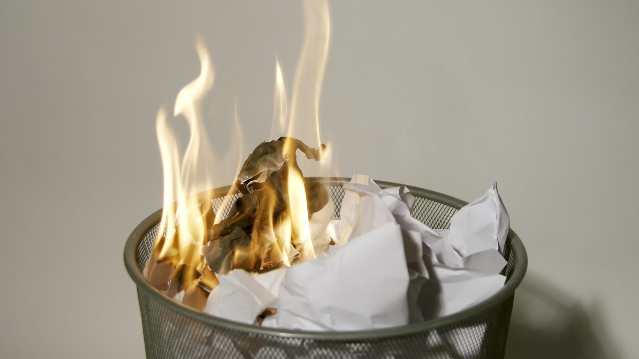 Fire in a wastepaper basket - stock photo