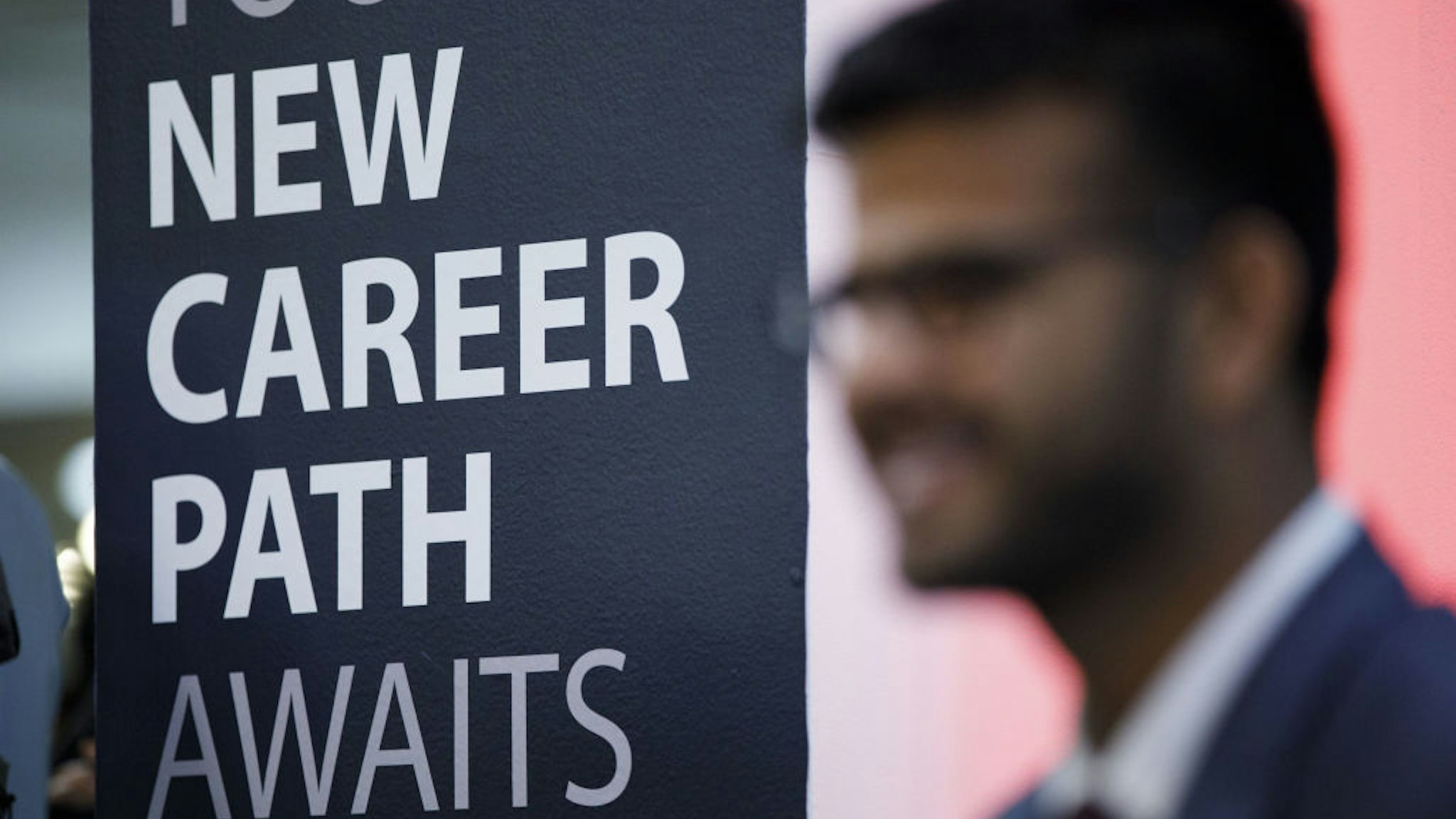 A sign reading "New Career Paths" is displayed during the TechFair LA career fair in Los Angeles, California, U.S., on Thursday, March 8, 2018. The U.S. Department of Labor is scheduled to release initial jobless claims on March 15. Photographer: Patrick T. Fallon/Bloomberg via Getty Images