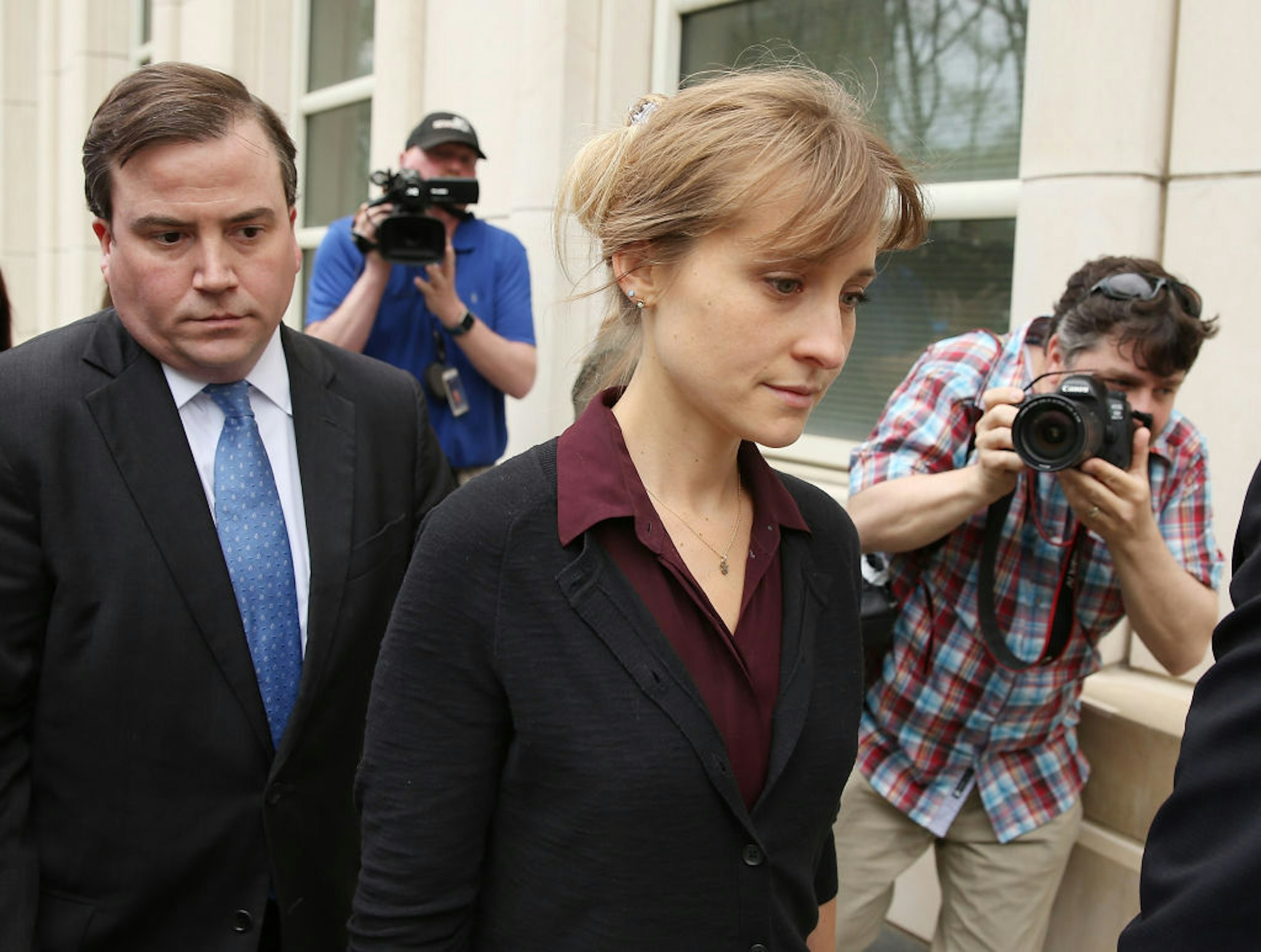 Actress Allison Mack (C) departs the United States Eastern District Court after a bail hearing in relation to the sex trafficking charges filed against her on May 4, 2018 in the Brooklyn borough of New York City.