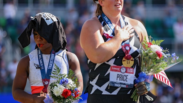 Gwendolyn Berry (L), third place, turns away from U.S. flag during the U.S. National Anthem as DeAnna Price (C), first place, also stands on the podium after the Women's Hammer Throw final on day nine of the 2020 U.S. Olympic Track &amp; Field Team Trials at Hayward Field on June 26, 2021 in Eugene, Oregon. In 2019, the USOPC reprimanded Berry after her demonstration on the podium at the Lima Pan-American Games. (Photo by Patrick Smith/Getty Images)