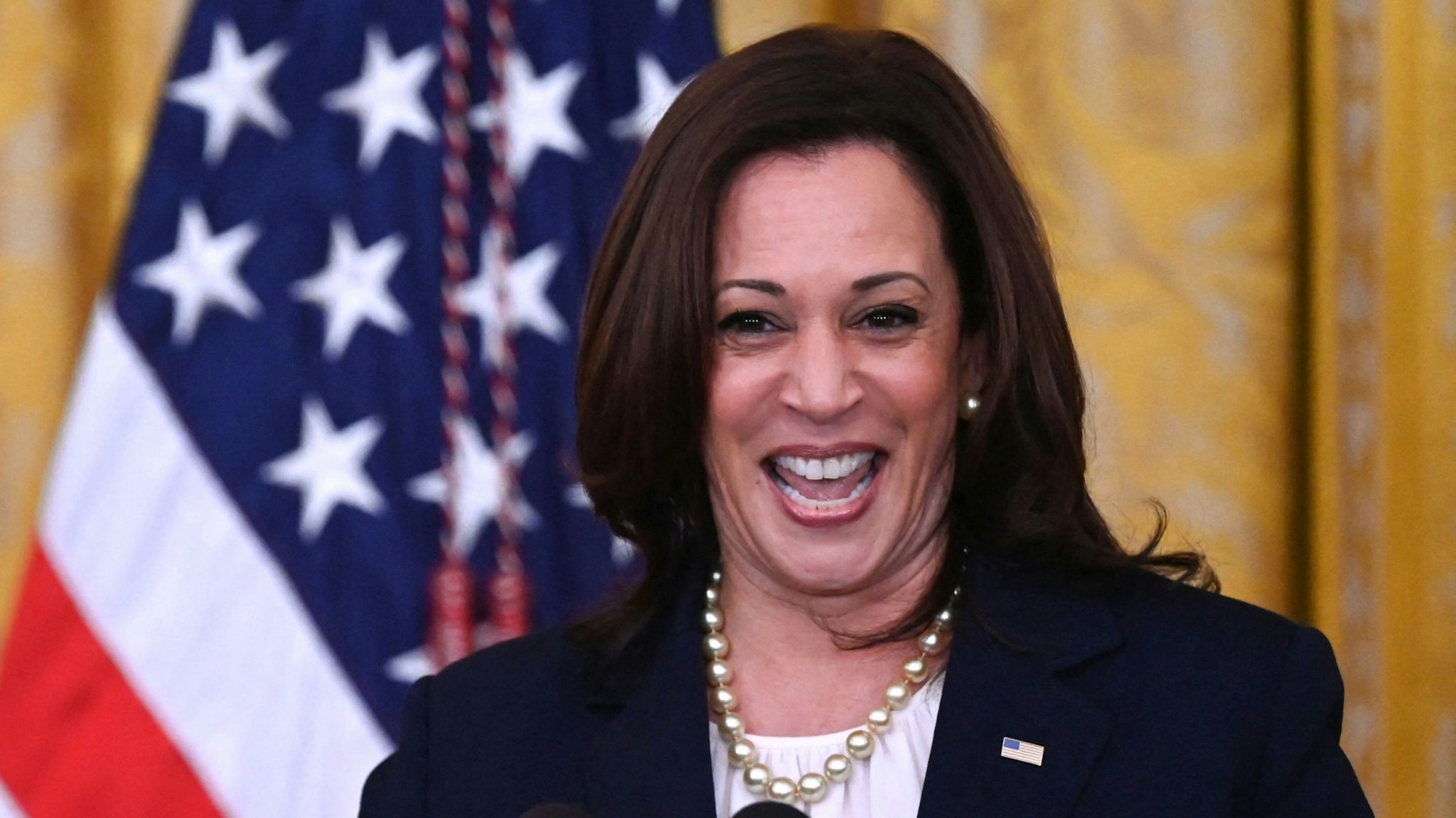 TOPSHOT - Vice President Kamala Harris speaks as President Joe Biden applauds on during an event to mark the passage of the Juneteenth National Independence Day Act, in the East Room of the White House, June 17, 2021, in Washington.
