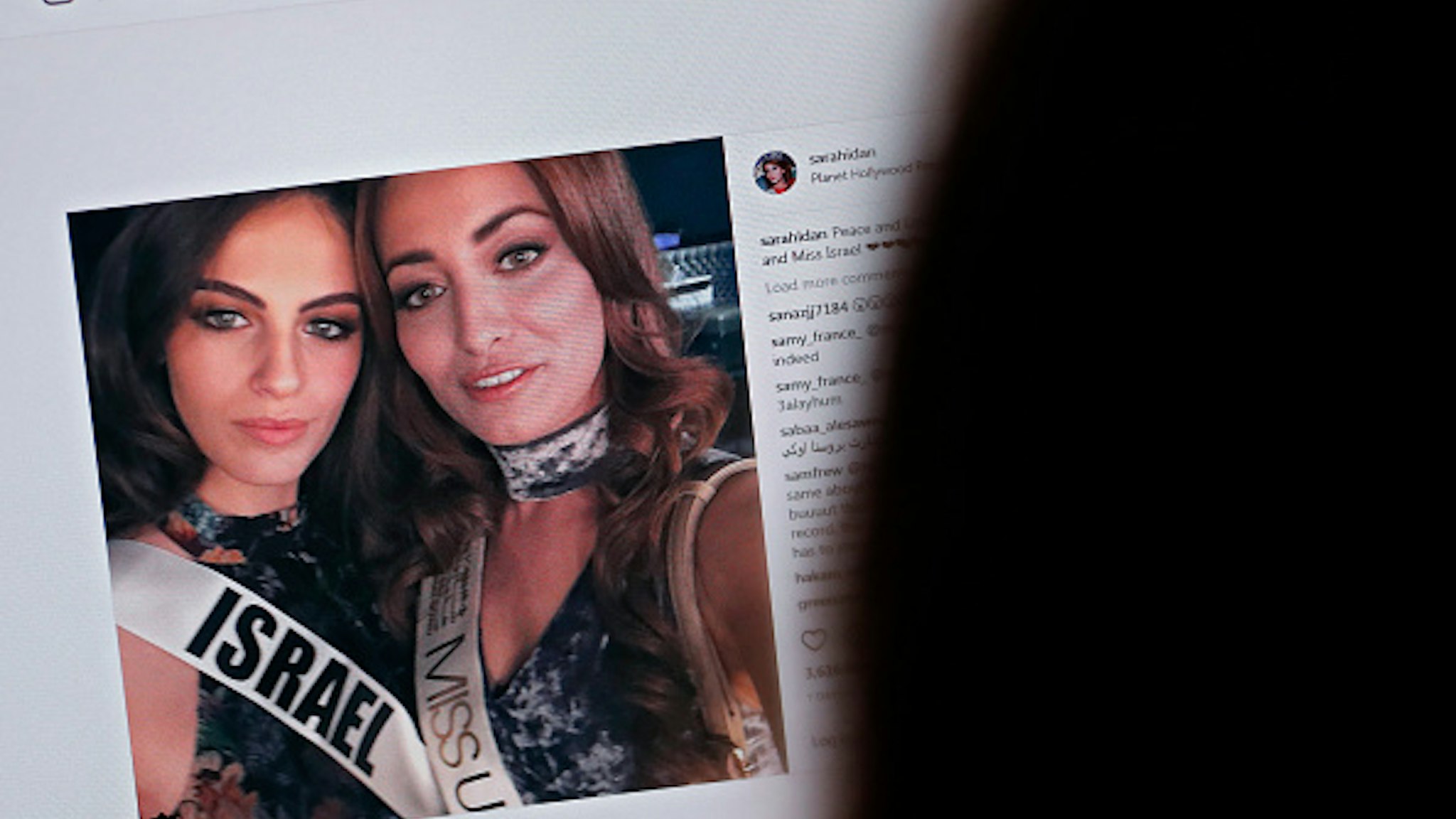 A picture taken on November 21, 2017 shows a picture posted by the Instagram profile of Sarah Idan on November 14, who holds the titles of "Miss Iraq USA 2016" and "Miss Iraq Universe 2017", as she is seen taking a "selfie" photograph with Adar Gandelsman, who holds the title of "Miss Universe Israel 2017", with a caption reading: "Peace and Love from Miss Iraq and Miss Israel #missuniverse". The post has been "liked" over 3,600 times since it was first uploaded but it also triggered an avalanche of comments, some positive and others negative in Iraq, which does not recognize the Jewish state and is still technically in a state of war with it. Both contestants defended the post saying they wanted to share a message of peace. / AFP PHOTO / THOMAS COEX / RESTRICTED TO EDITORIAL USE - MANDATORY MENTION OF THE ARTIST UPON PUBLICATION - TO ILLUSTRATE THE EVENT AS SPECIFIED IN THE CAPTION