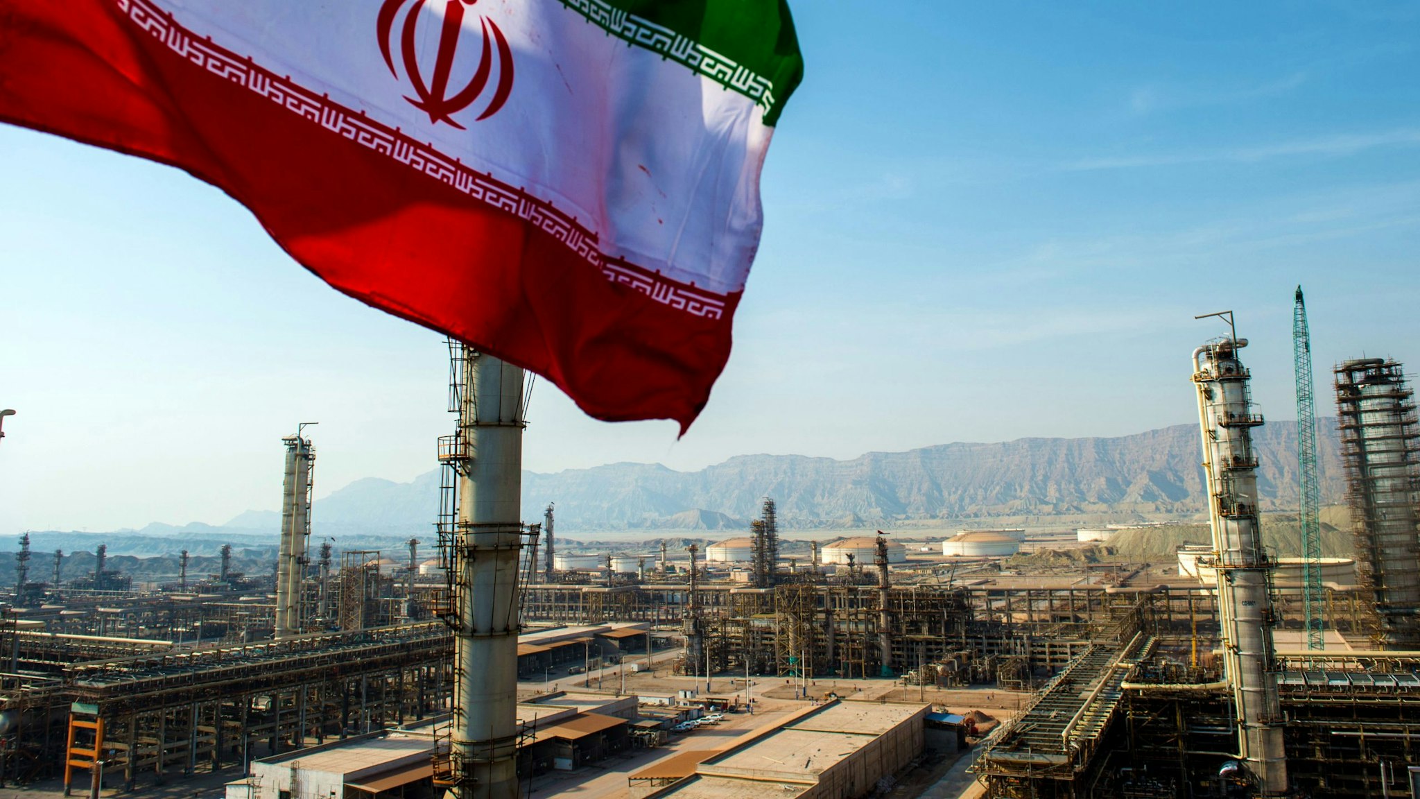 An Iranian national flag flies above the new Phase 3 facility at the Persian Gulf Star Co. (PGSPC) gas condensate refinery in Bandar Abbas, Iran, on Wednesday, Jan. 9. 2019. The third phase of the refinery begins operations next week and will add 12-15 million liters a day of gasoline output capacity to the plant, Deputy Oil Minister Alireza Sadeghabadi told reporters.