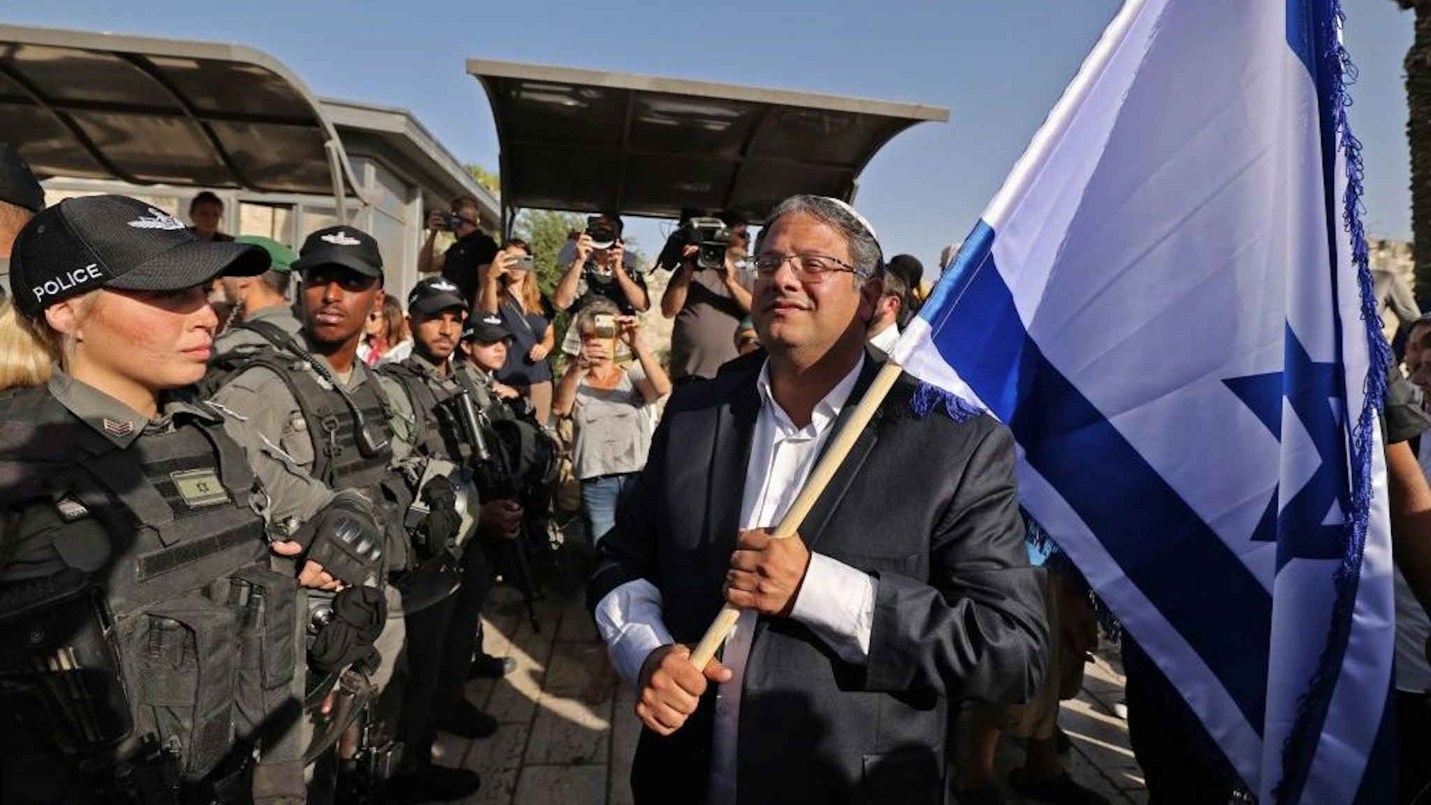 Itamar Ben-Gvir, member of Israel's Knesset (parliament) and head of the one-man far right "Jewish Power" (Otzma Yehudit) party, waves an Israeli flag as he attempts to march to Damascus Gate in east Jerusalem, on June 10, 2021. (Photo by EMMANUEL DUNAND / AFP) (Photo by EMMANUEL DUNAND/AFP via Getty Images)