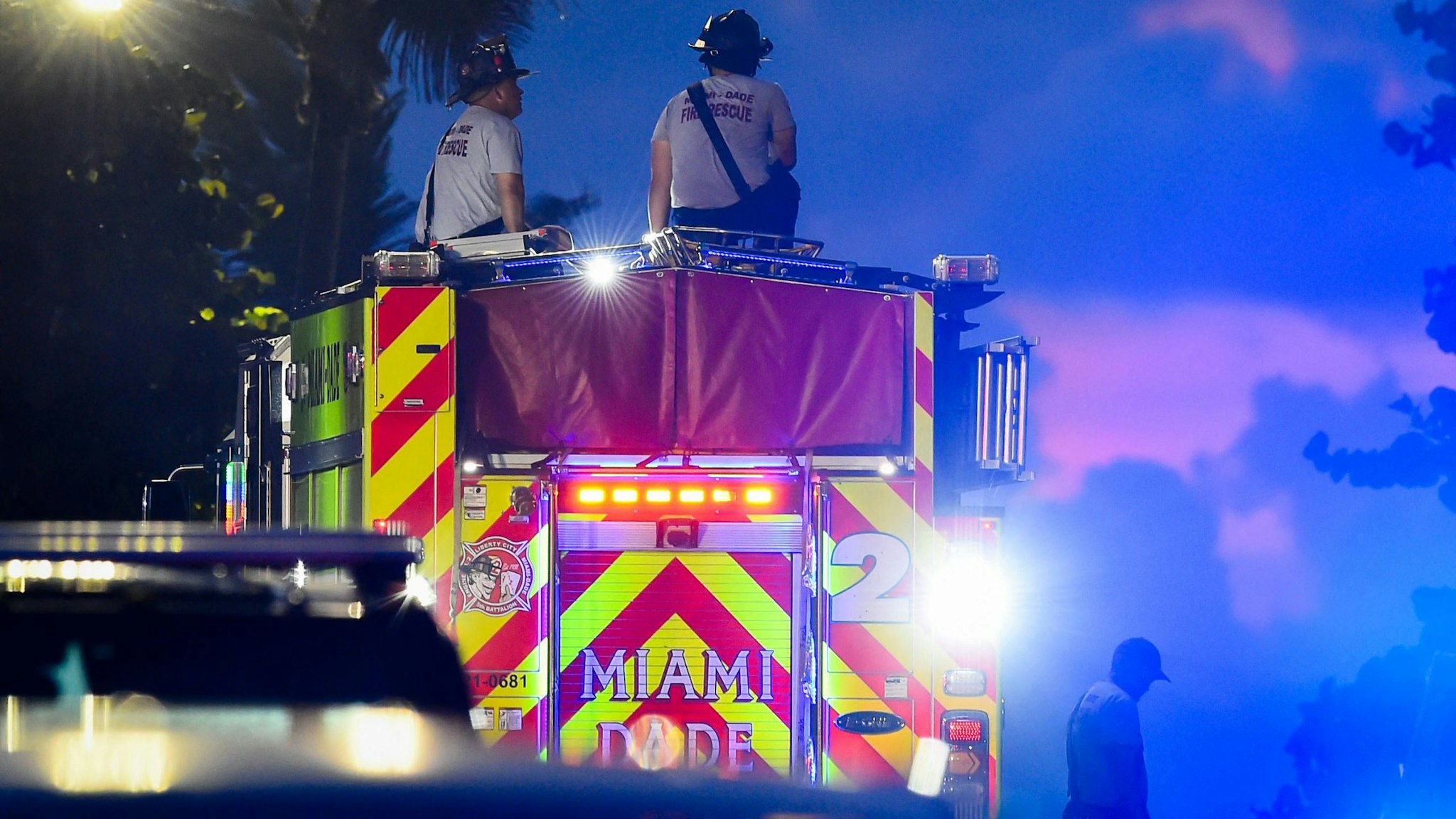 A Miami-Dade firefighter works during a rescue operation of a partially collapsed building in Surfside north of Miami Beach, Florida on June 25, 2021. - Four people are now known to have died in the collapse of an oceanfront apartment building near Miami Beach, officials said Friday, while the number of unaccounted for has risen to 159 -- fueling fears of a much higher death toll.