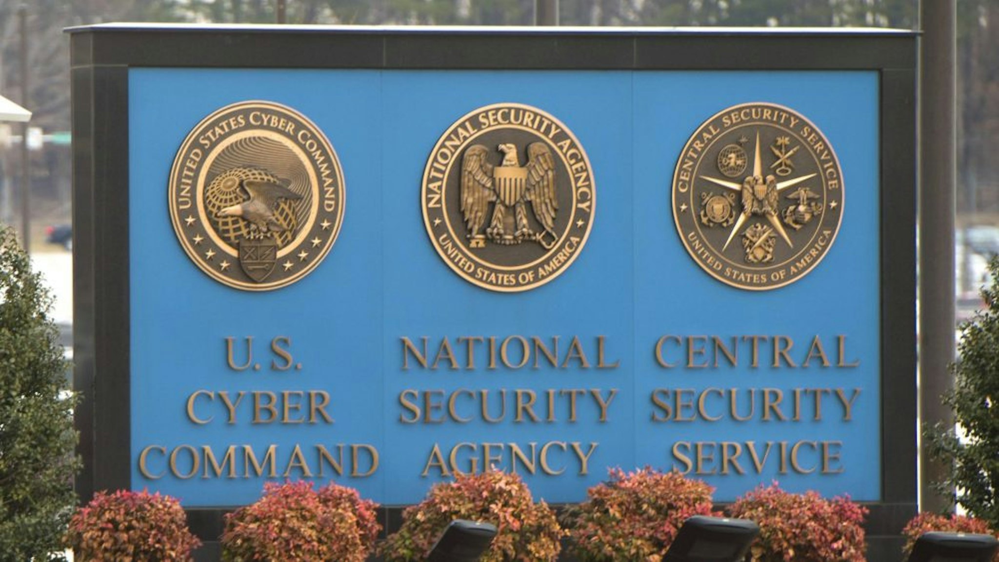 A sign for the National Security Agency (NSA), US Cyber Command and Central Security Service, is seen near the visitor's entrance to the headquarters of the National Security Agency (NSA) after a shooting incident at the entrance in Fort Meade, Maryland, February 14, 2018. - Shots were fired early Wednesday at the ultra-secret National Security Agency, the US electronic spying agency outside Washington, leaving one person injured, officials said. Aerial footage of the scene from NBC News showed a black SUV with numerous bullet holes in its windshield crashed into concrete barriers at the main entrance to the NSA's headquarters in Fort Meade, Maryland.