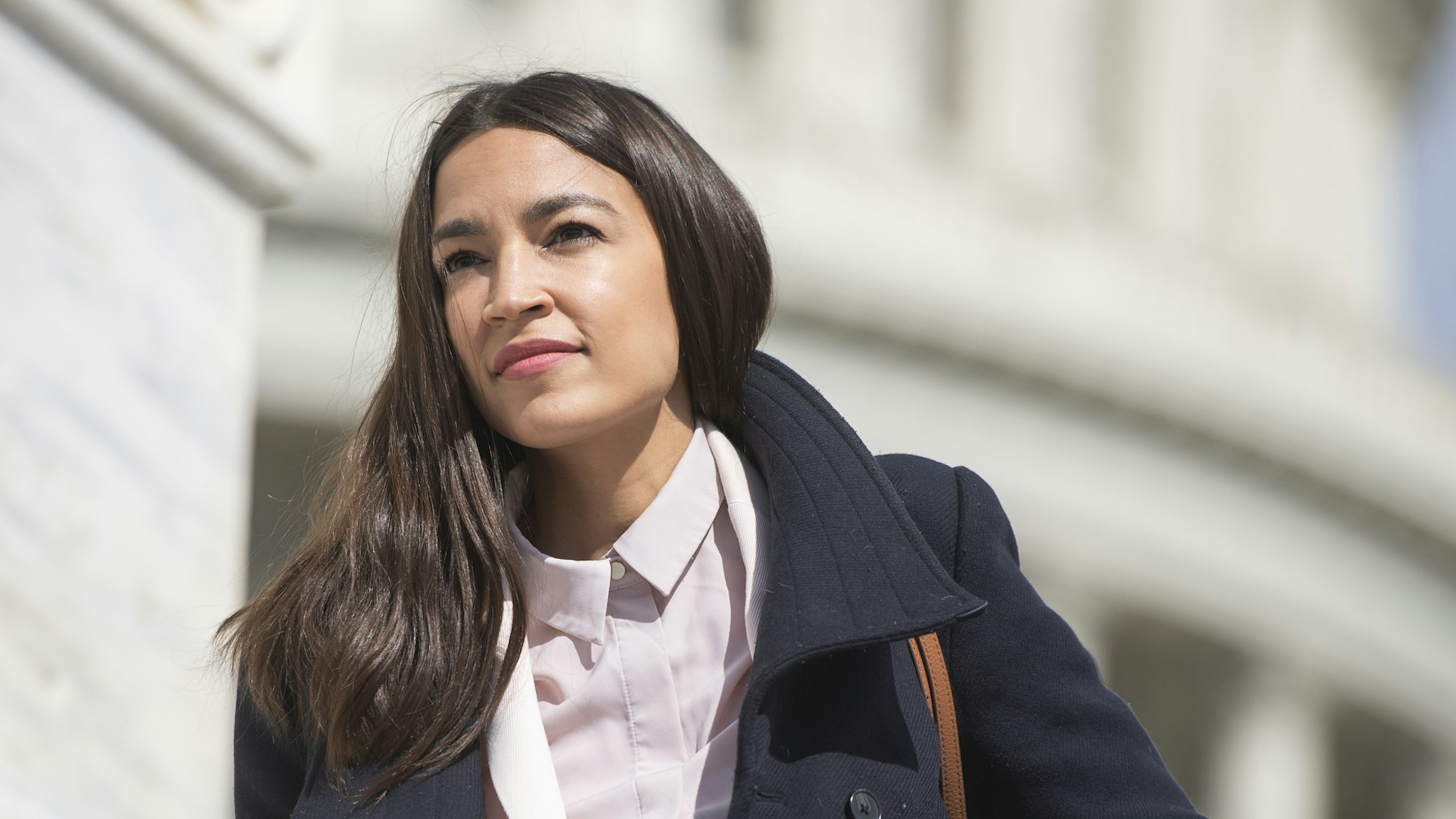 Rep. Alexandria Ocasio-Cortez, D-N.Y., is seen on the House steps of the Capitol before the House passed a $2 trillion coronavirus aid package by voice vote on Friday, March 27, 2020. (Photo By Tom Williams/CQ Roll Call)