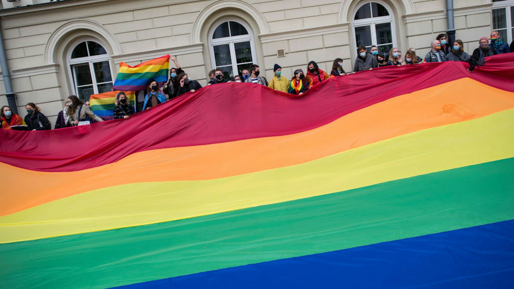 WARSAW, POLAND - 2020/10/01: Activists hold a massive rainbow flag at the university campus during the protest.