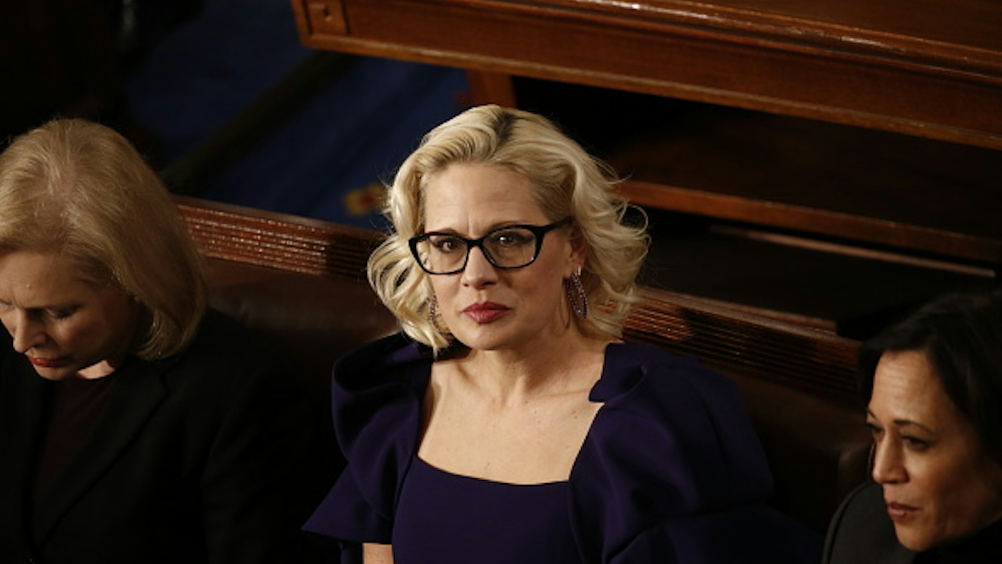 Senator Kyrsten Sinema, a Democrat from Arizona, center, sits ahead of a State of the Union address to a joint session of Congress at the U.S. Capitol in Washington, D.C., U.S., on Tuesday, Feb. 4, 2020. President Donald Trump will try to move past his impeachment and make a case for his re-election in Tuesday's State of the Union address by taking credit for a strong economy, newly signed trade deals and an immigration crackdown.