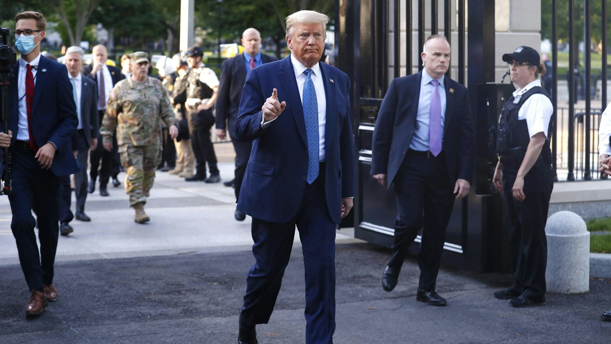 U.S. President Donald Trump returns to the White House after posing with a bible outside St. John's Episcopal Church in Washington, D.C., U.S., on Monday, June 1, 2020. Trump promised a forceful response to violent protests across the country before leaving the White House to visit a church across the street that had been been damaged by fires.