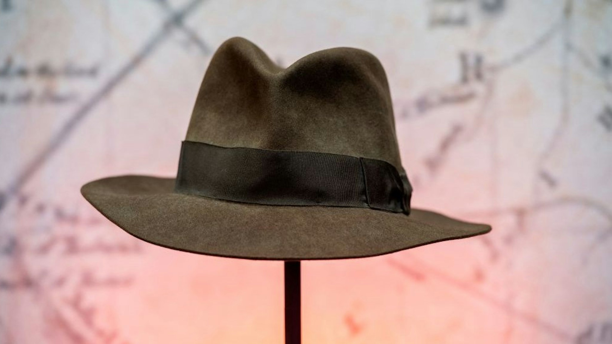 Harrison Ford's Indiana Jones' fedora hat from the movie "Indiana Jones &amp; the Temple of Doom" is exhibited during a press preview of Prop Store's Iconic Film &amp; TV Memorabilia on May 14, 2021, in Valencia, California. - Over 1,200 items from Hollywood folklore will go on sale in June and July, including Princess Leia actor Carrie Fisher's "Star Wars: The Empire Strikes Back" script, the custom-made hat worn by Harrison Ford in 1984 action classic "Indiana Jones and the Temple of Doom" and Tom Cruise's sword from "The Last Samurai." (Photo by VALERIE MACON / AFP) (Photo by