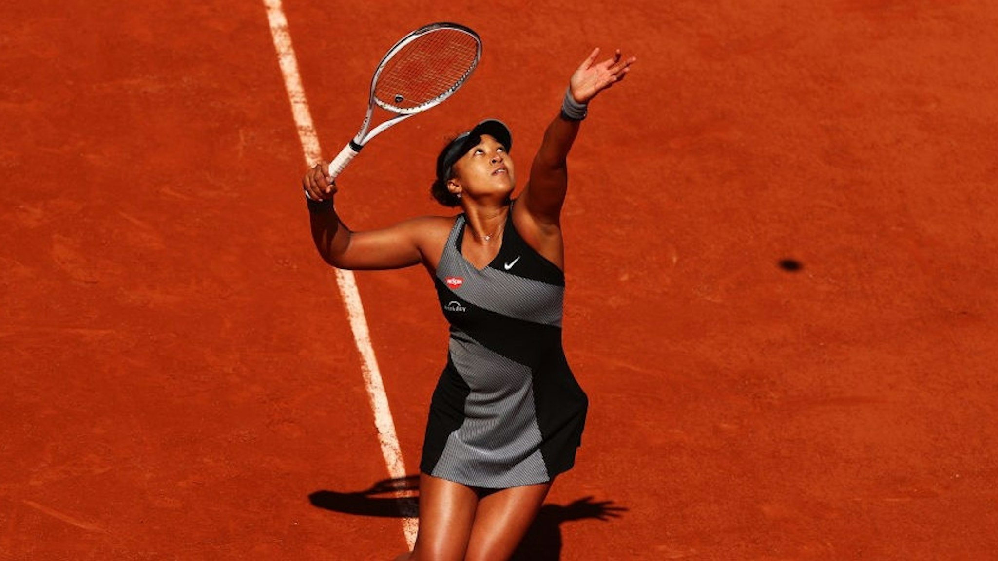 PARIS, FRANCE - MAY 30: Naomi Osaka of Japan serves in her First Round match against Patricia Maria Tig of Romania during Day One of the 2021 French Open at Roland Garros on May 30, 2021 in Paris, France. (Photo by