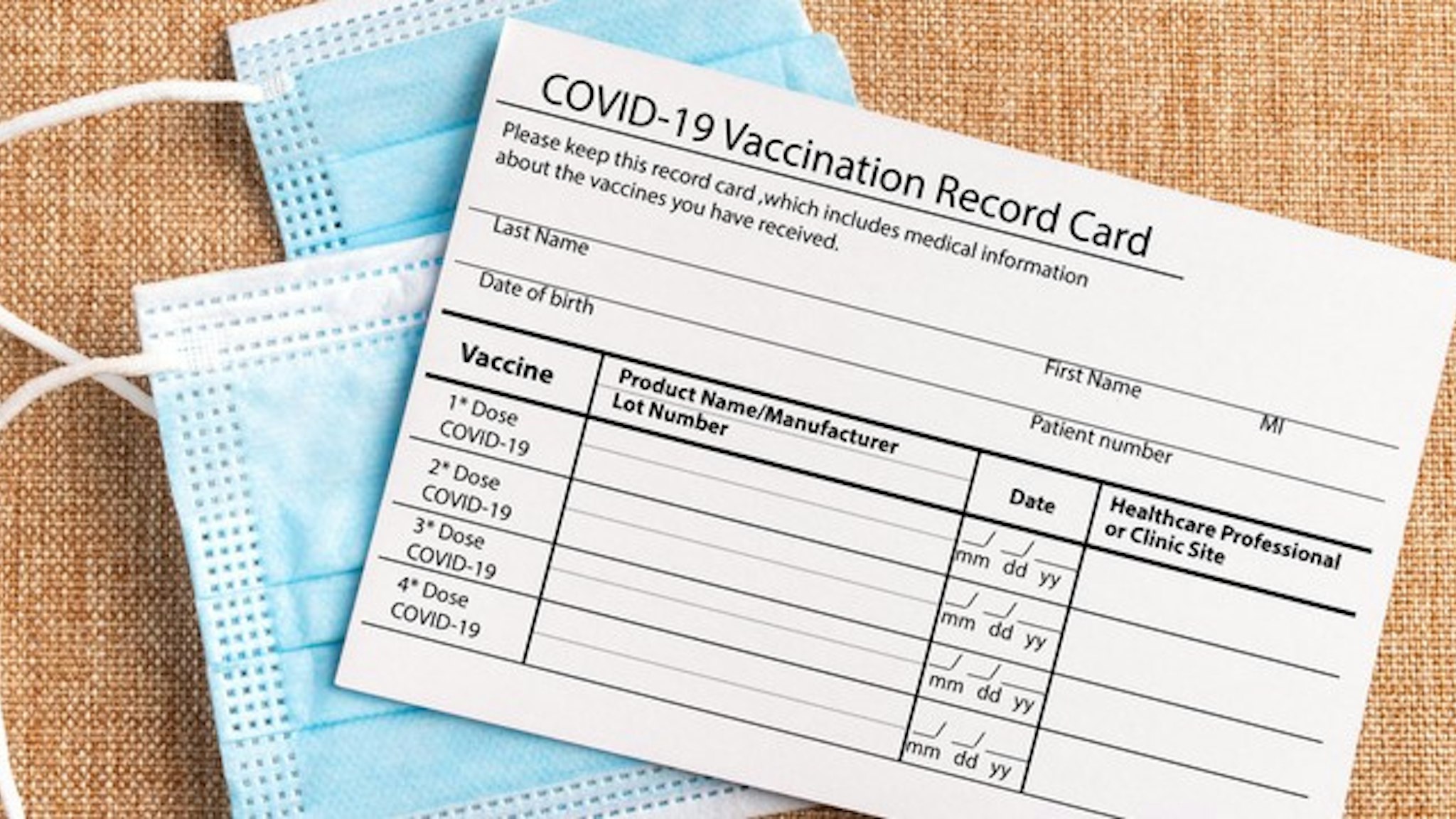 Coronavirus vaccination record card. Protective mask divided into two parts. Concept of defeating Covid-19