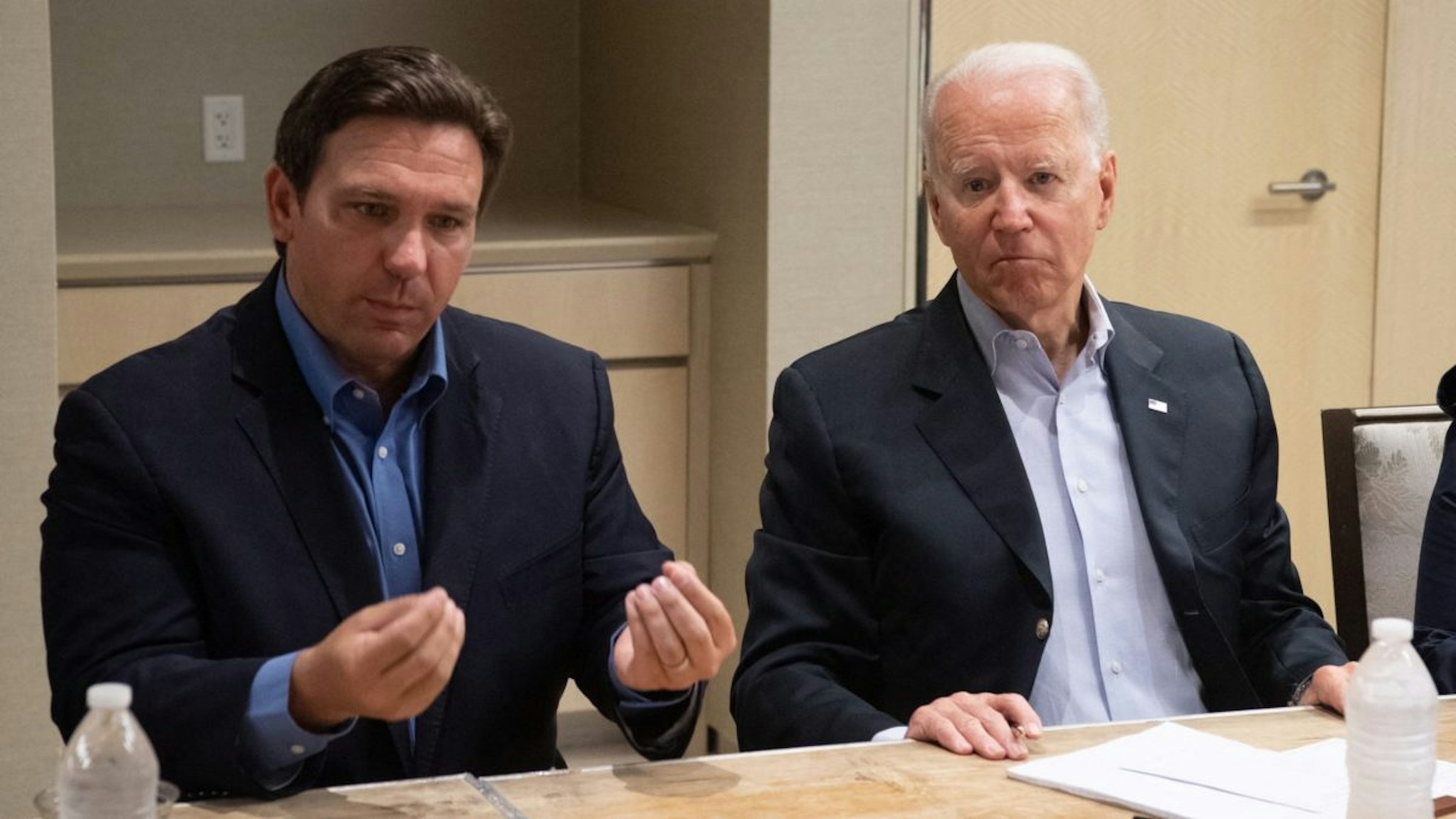 US President Joe Biden alongside Florida Governor Ron DeSantis (L) speaks about the collapse of the 12-story Champlain Towers South condo building in Surfside, during a briefing in Miami Beach, Florida, July 1, 2021.