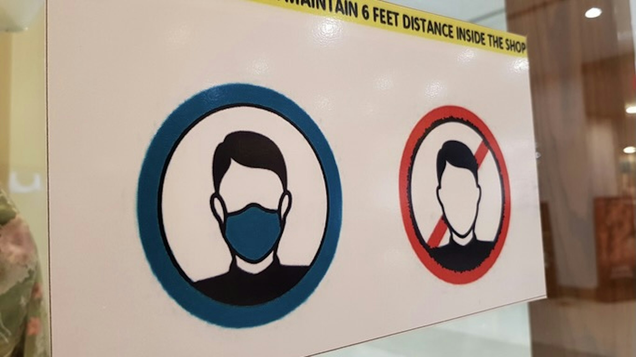Safety or warning signs for wearing surgical face mask before entering in shops during Corona Virus (Covid-19) pandemic. - stock photo Corona Virus precautionary and safety signs on and near shops in the markets. Amir Mukhtar via Getty Images