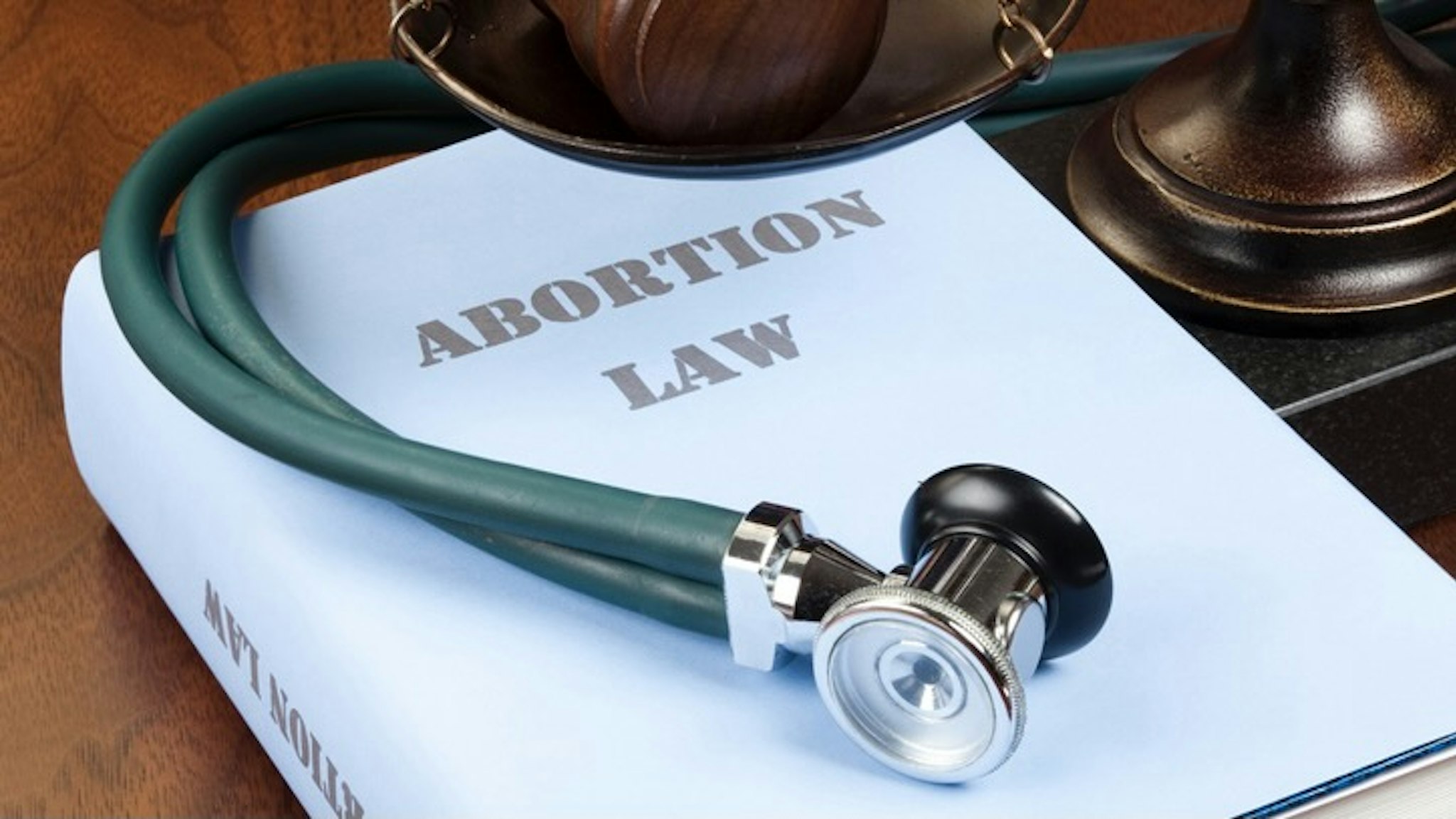 Abortion law - stock photo "Concept shot. Gavel, stethoscope and scale of justice next to Abortion Law book." ericsphotography via Getty Images