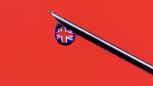 Coronavirus vaccine, COVID-19 in United Kingdom. Global pandemic. - stock photo Close-up syringe with United Kingdom flag in a drop. Coronavirus pandemic concept. Vaccine Anton Petrus via Getty Images