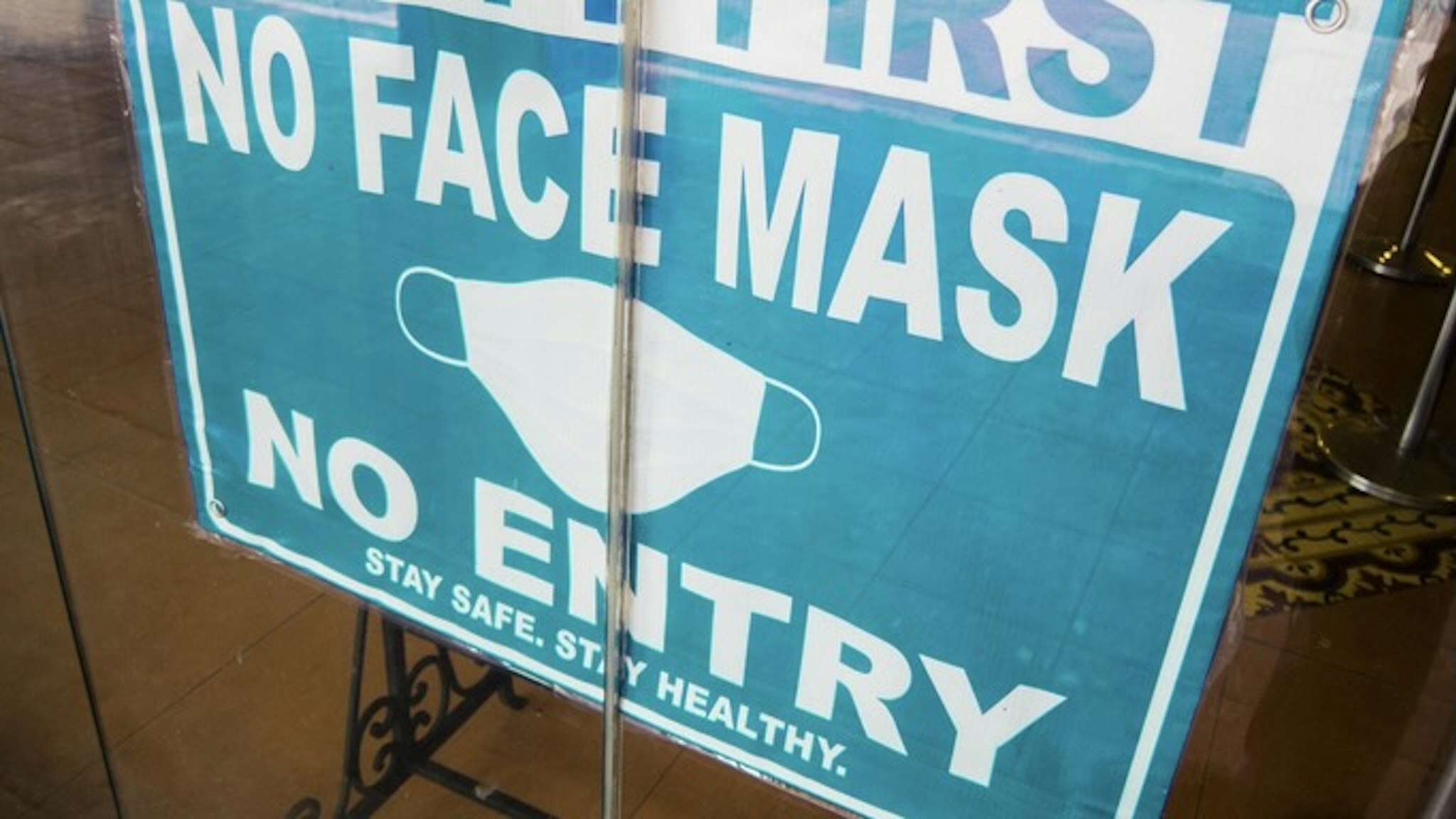 No Mask No Entry sign in a store window - stock photo Close-up view of No Mask No Entry sign in a store window amidst Coronavirus Pandemic Karl Tapales via Getty Images