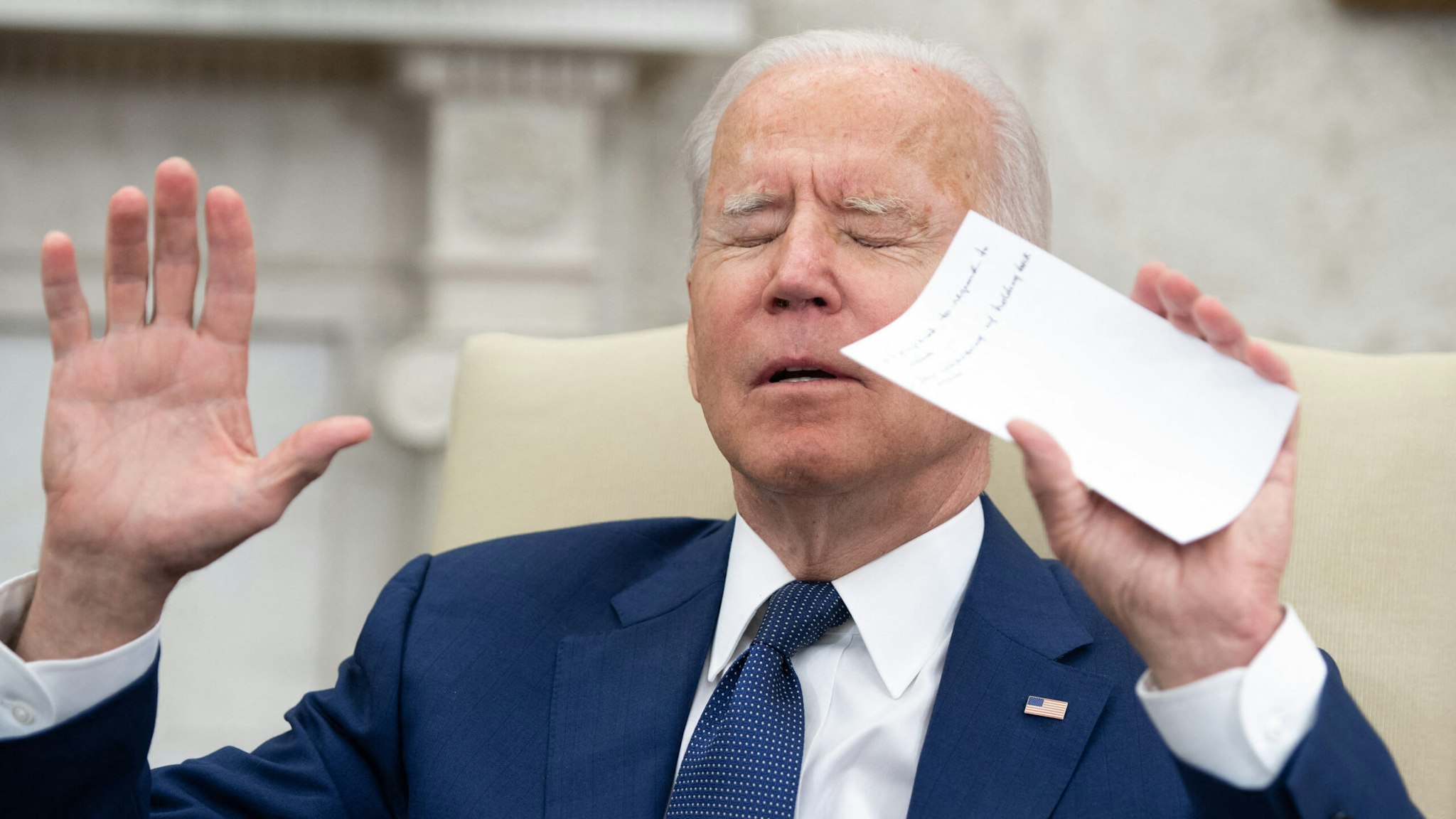 US President Joe Biden tries to get members of the media to stop shouting questions as he meets with Iraqi Prime Minister Mustafa Al-Kadhimi in the Oval Office of the White House in Washington, DC, July 26, 2021.