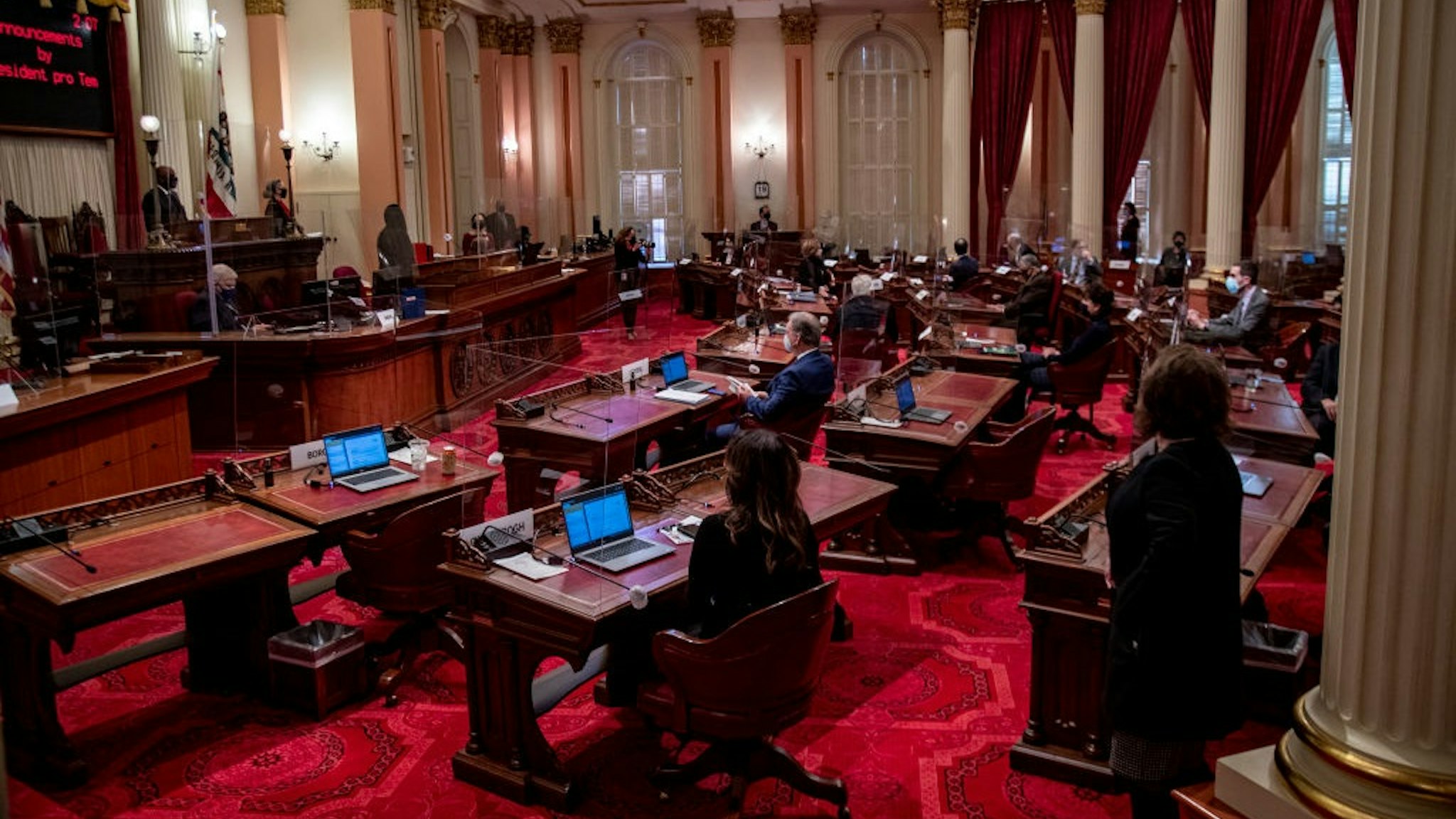 SACRAMENTO, CA -JANUARY 19, 2021: Plexiglass partitions have been set up in the Senate chamber because of Covid during a session in the Capitol on January 19, 2021 in Sacramento, California.