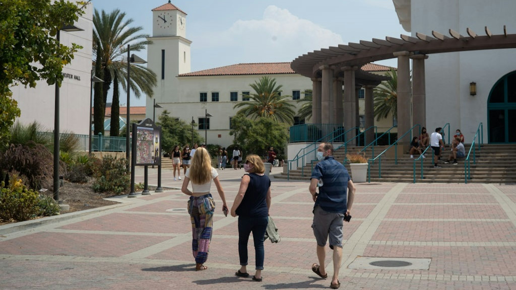 Students and parents walk on campus during move-in day at San Diego State University in San Diego, California, U.S., on Friday, Aug. 21, 2020.