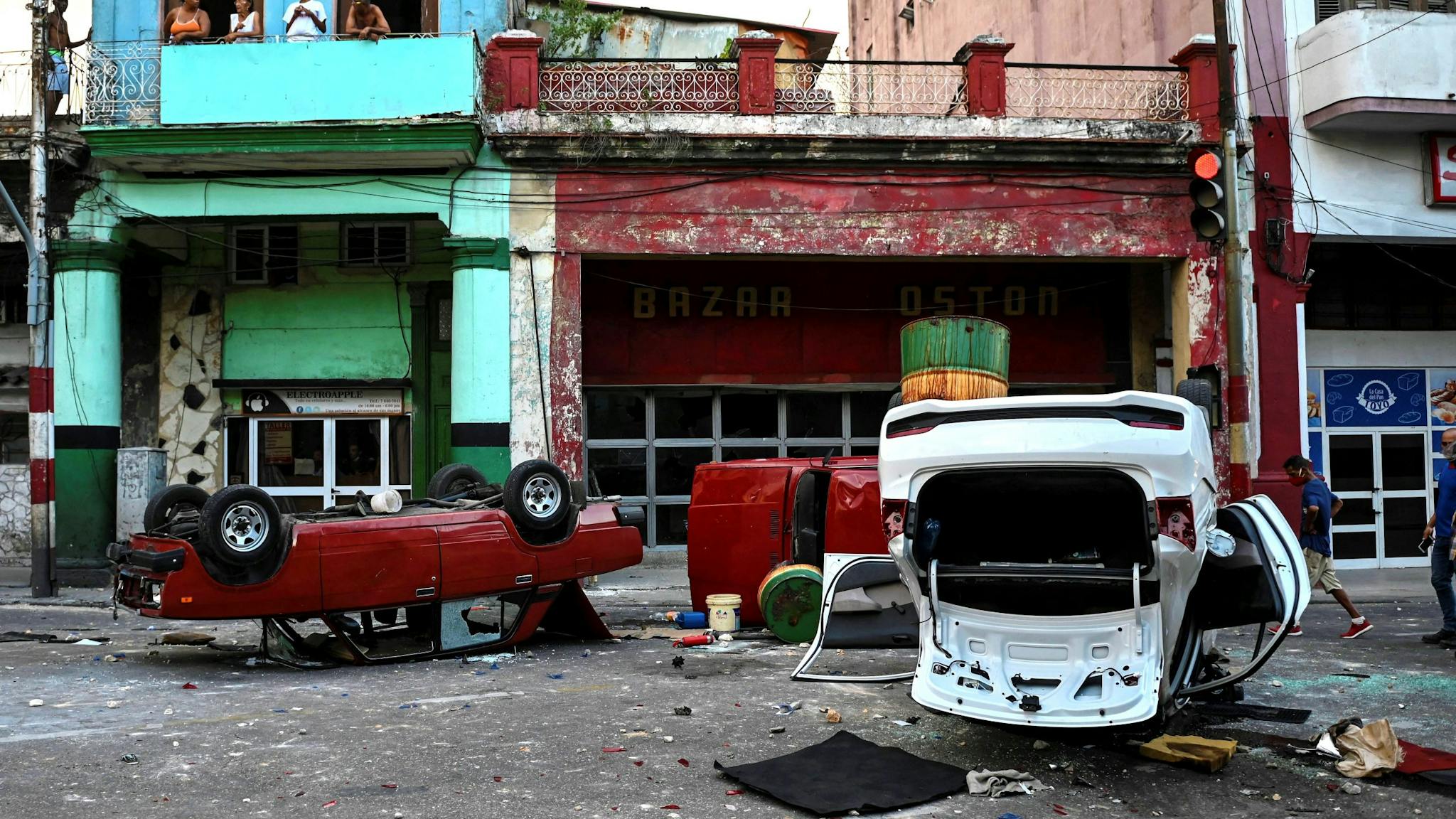 CUBA-POLITICS-DEMONSTRATION-DIAZ-CANEL Police cars are seen overturned in the street in the framework of a demonstration against Cuban President Miguel Diaz-Canel in Havana, on July 11, 2021. - Thousands of Cubans took part in rare protests Sunday against the communist government, marching through a town chanting "Down with the dictatorship" and "We want liberty."