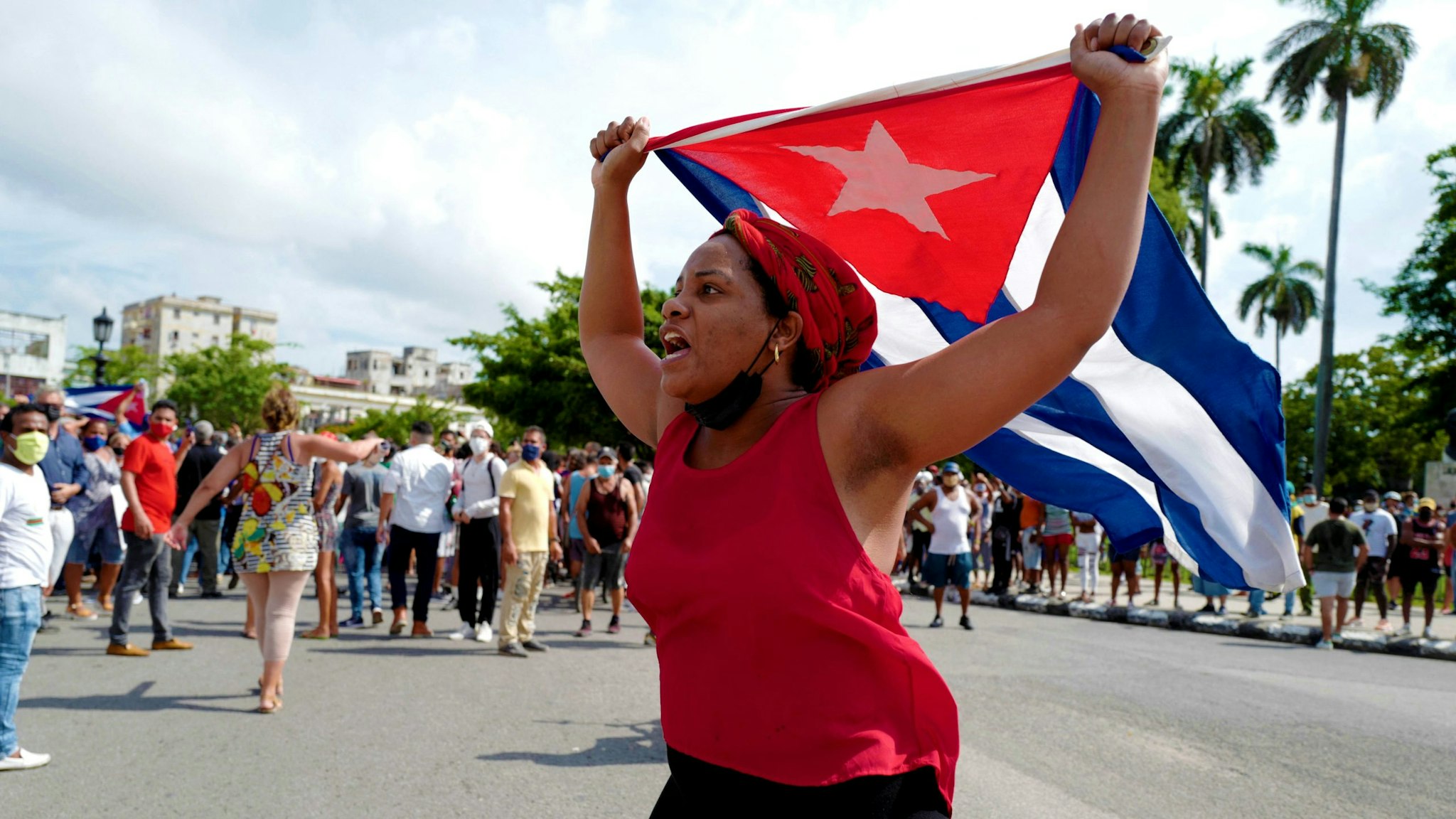 A pro-government woman is seen during a demonstration against the government of Cuban President Miguel Diaz-Canel in Havana, on July 11, 2021. - Thousands of Cubans took part in rare protests Sunday against the communist government, marching through a town chanting "Down with the dictatorship" and "We want liberty."