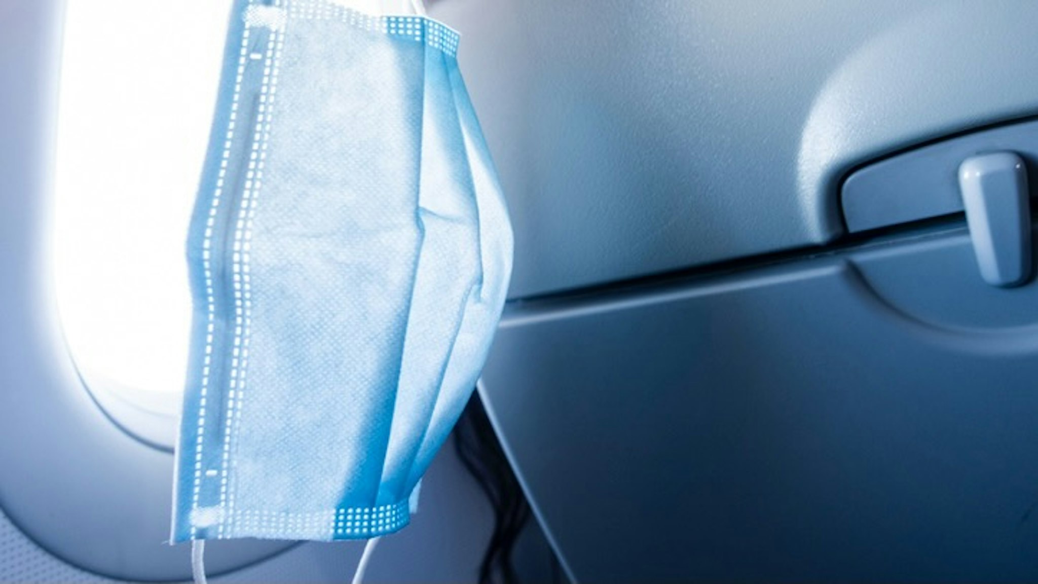 Surgical masks in airplane - stock photo DuKai photographer via Getty Images