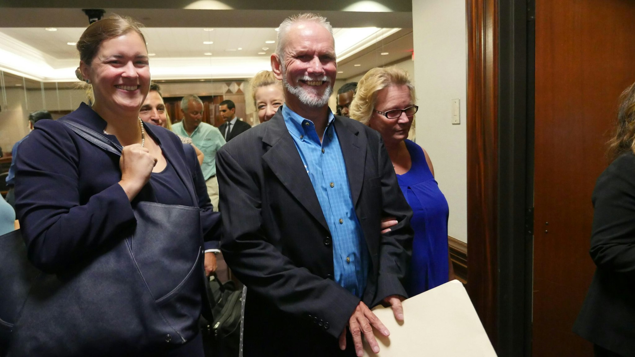 Dennis Perry, 59, smiles as he leaves the courtroom after being exonerated for a murder he didn't commit.
