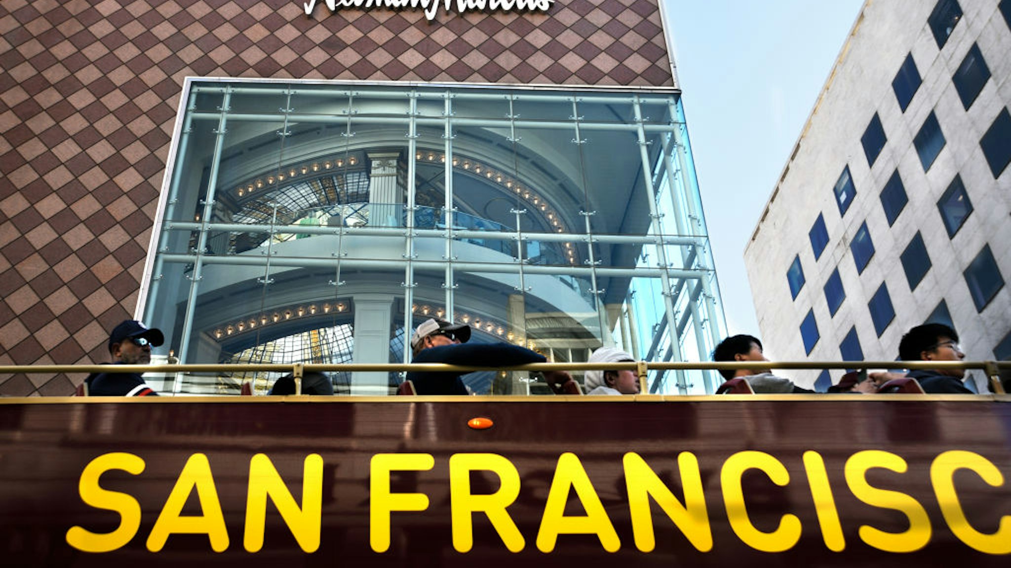 SAN FRANCISCO, CALIFORNIA - SEPTEMBER 13, 2018: Tourists ride a sightseeing bus past a Neiman Marcus store in San Francisco, California. (Photo by Robert Alexander/Getty Images)